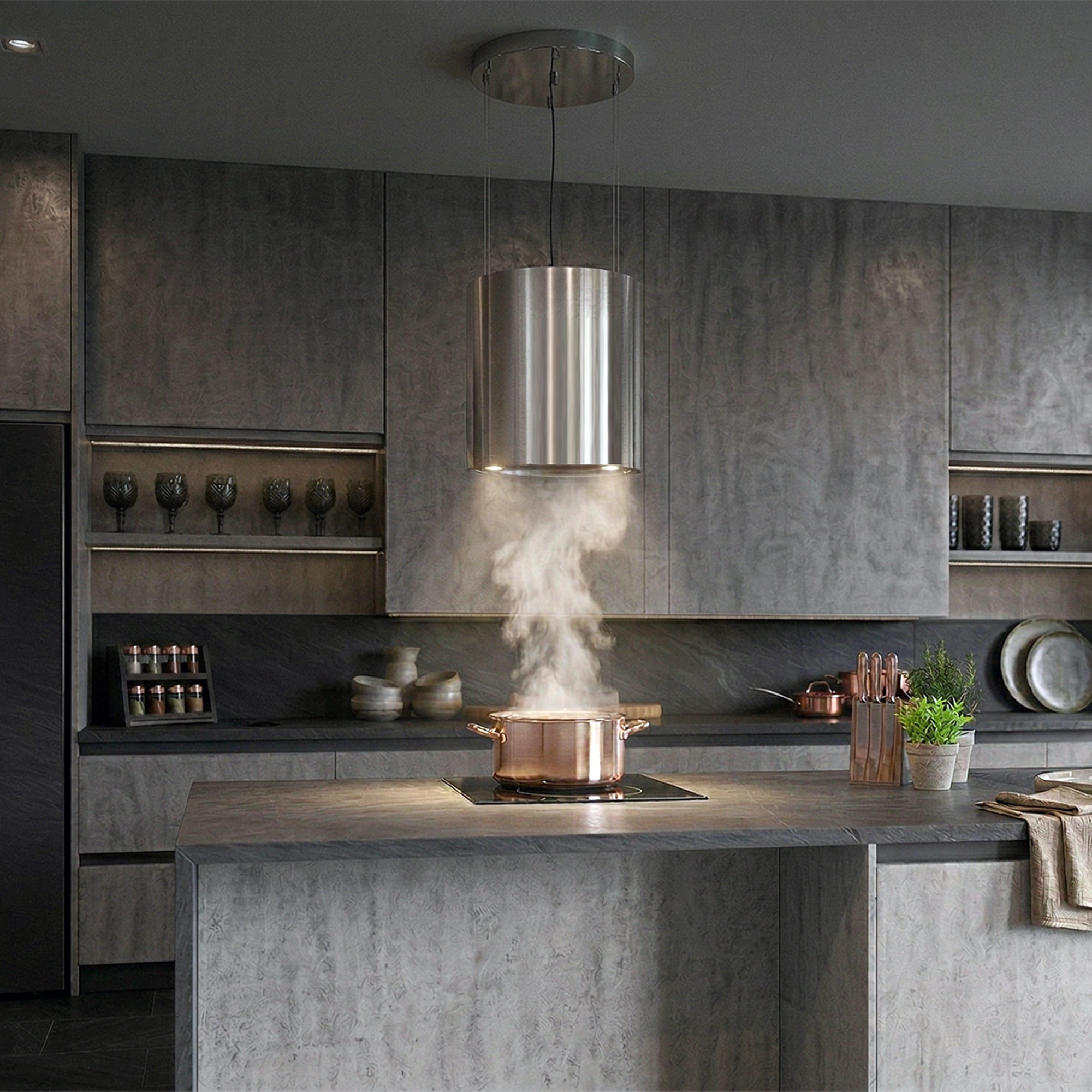 Stainless steel island range hood above a kitchen cooktop with chimney column