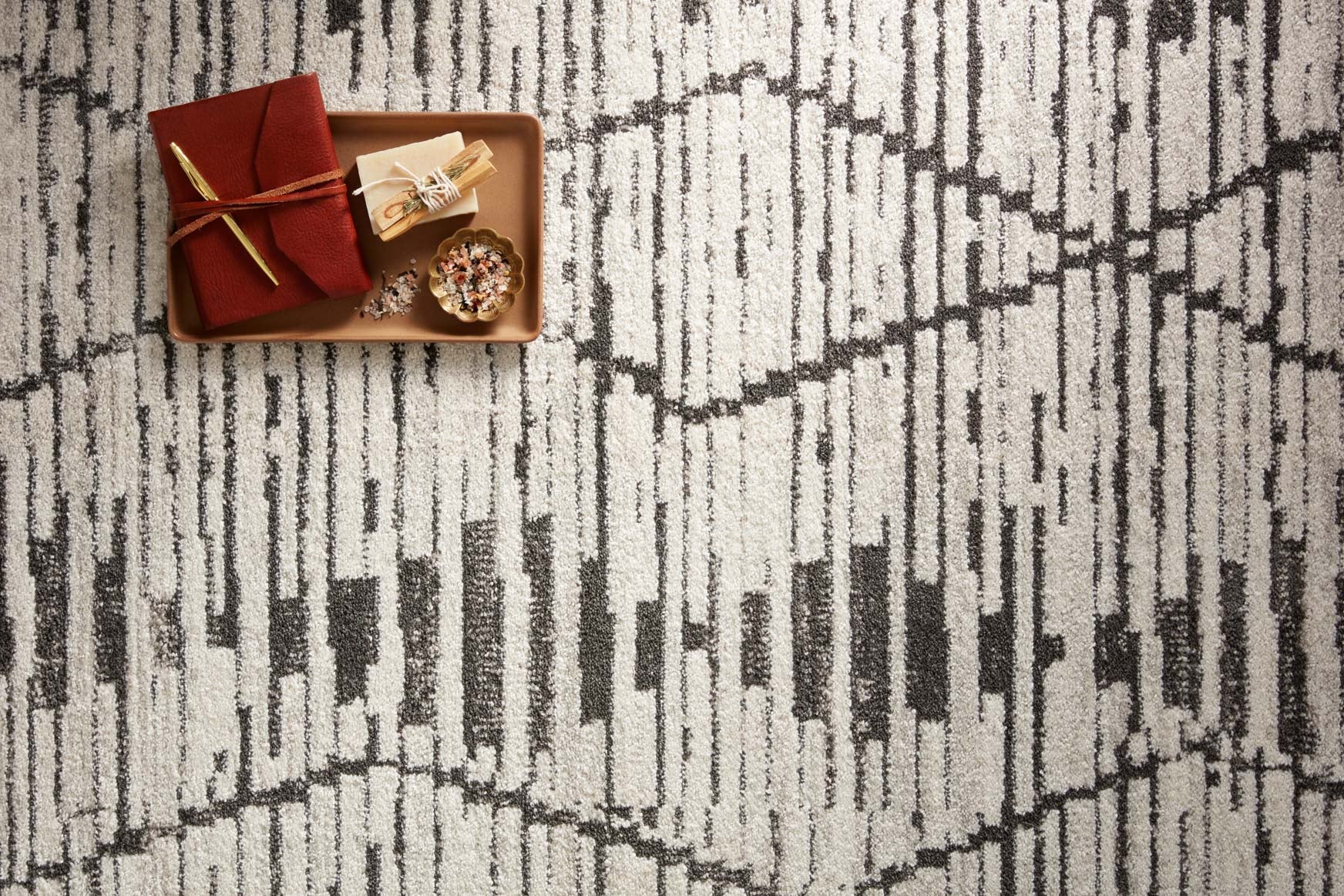 Close-up of charcoal-and-dove rug pattern with raised textured lines