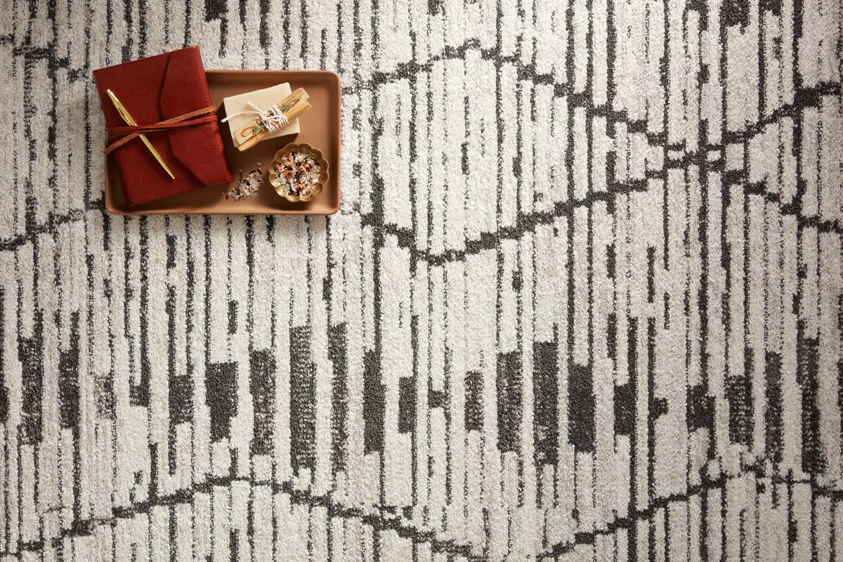 Charcoal and dove accent rug with distressed vertical strokes and diamond lattice pattern