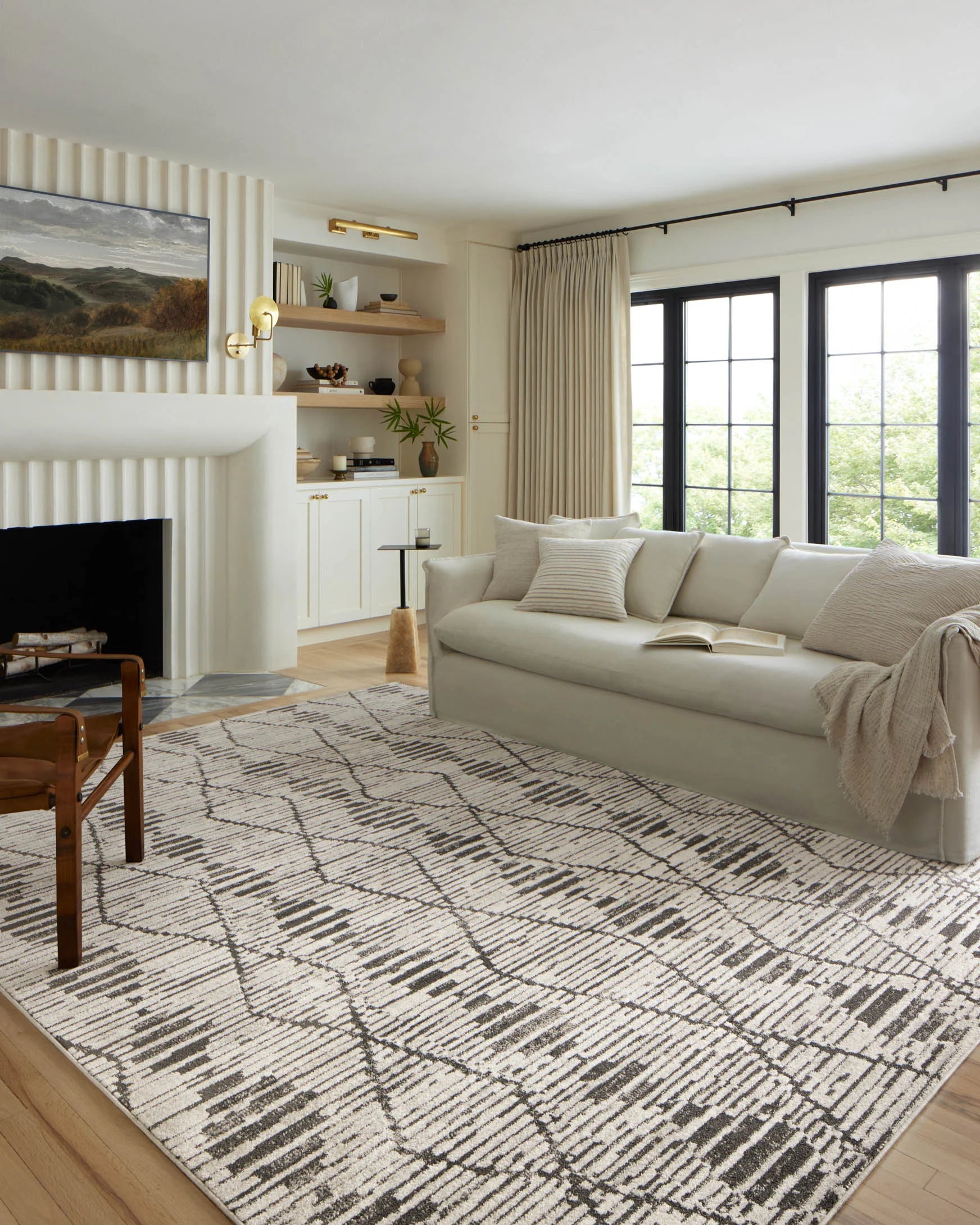 Large geometric charcoal and dove area rug with diamond lattice pattern on hardwood floor