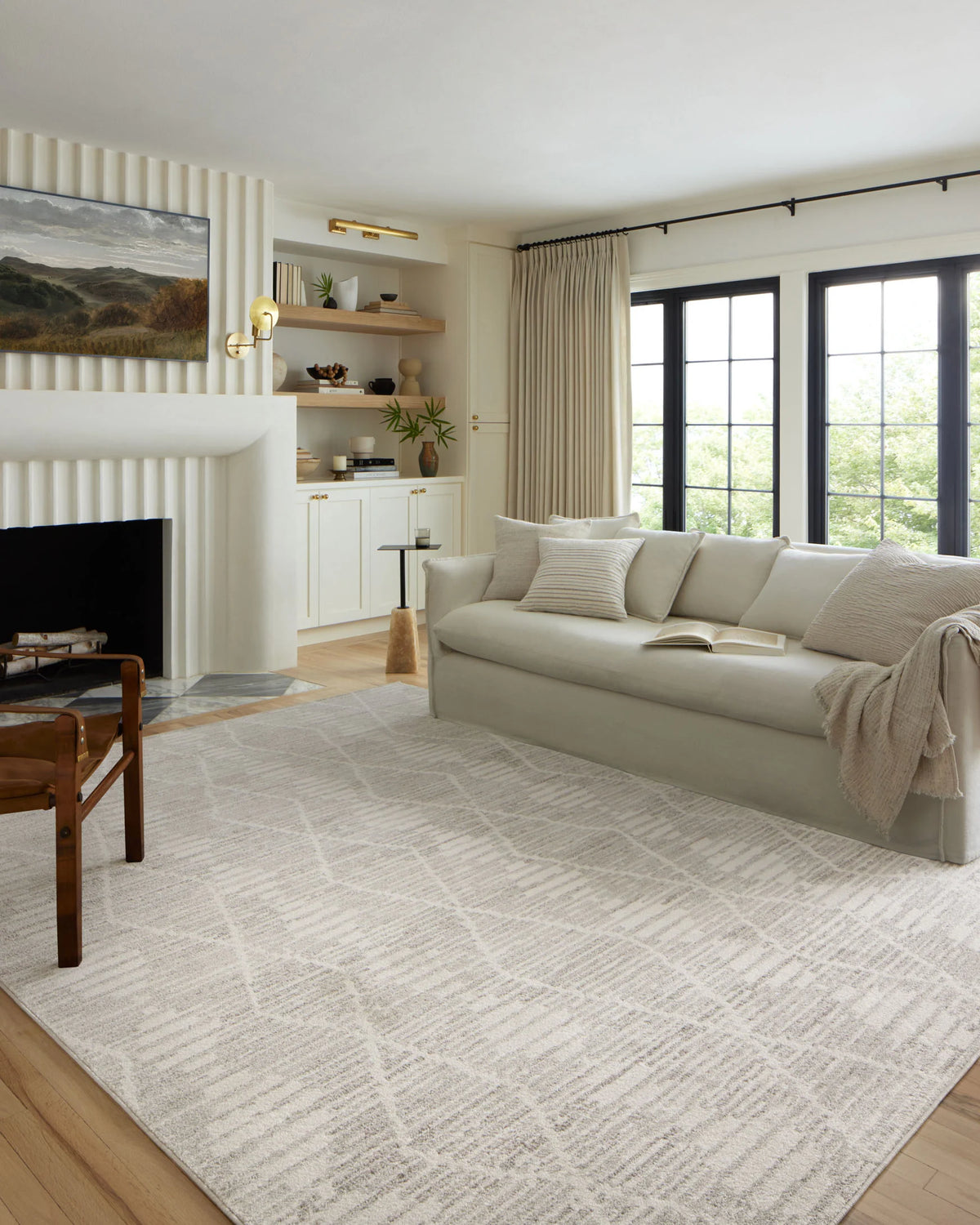 Ivory and silver transitional area rug with textured abstract pattern on the floor.
