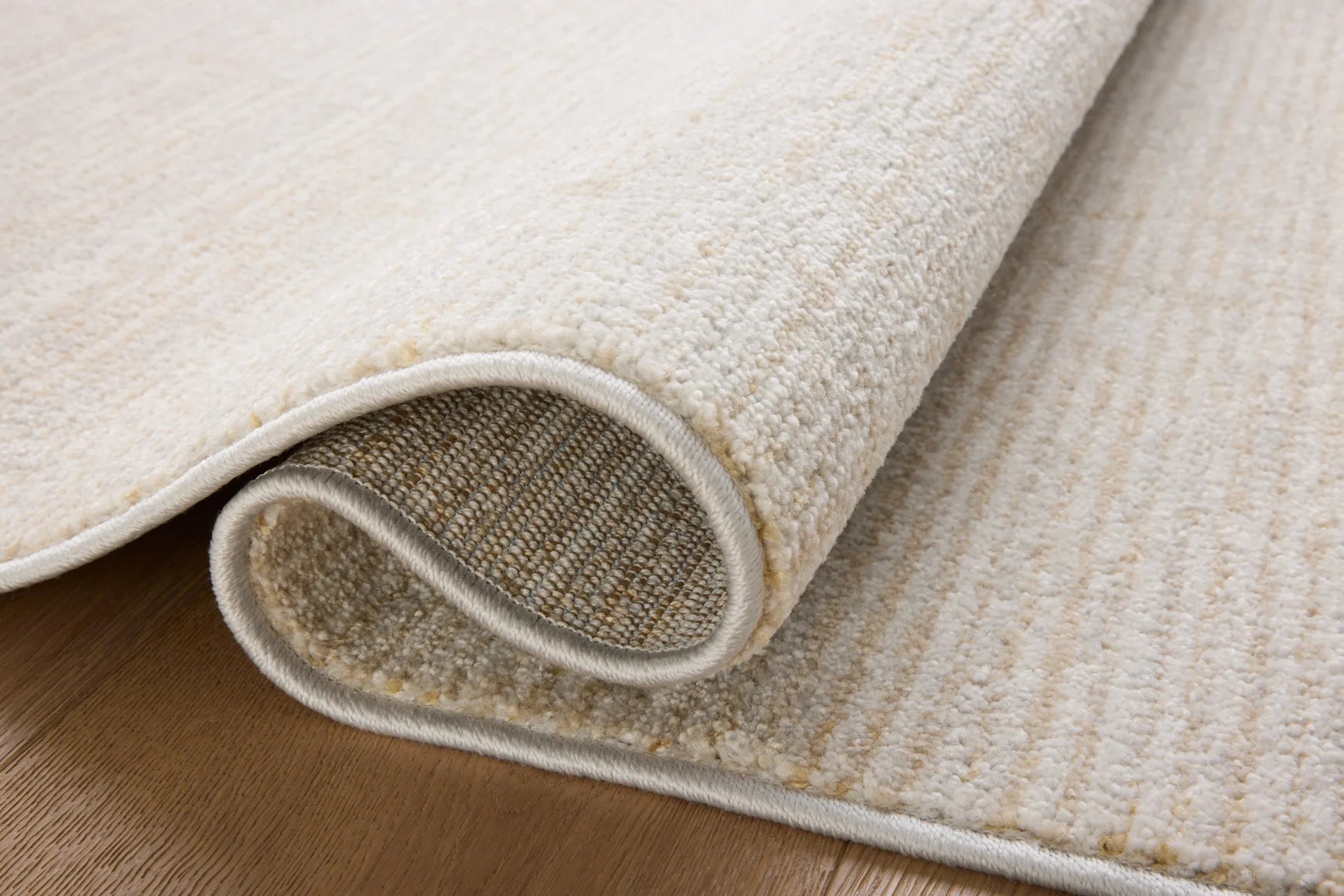 Runner rug edge with bound border and short textured pile, showing underside
