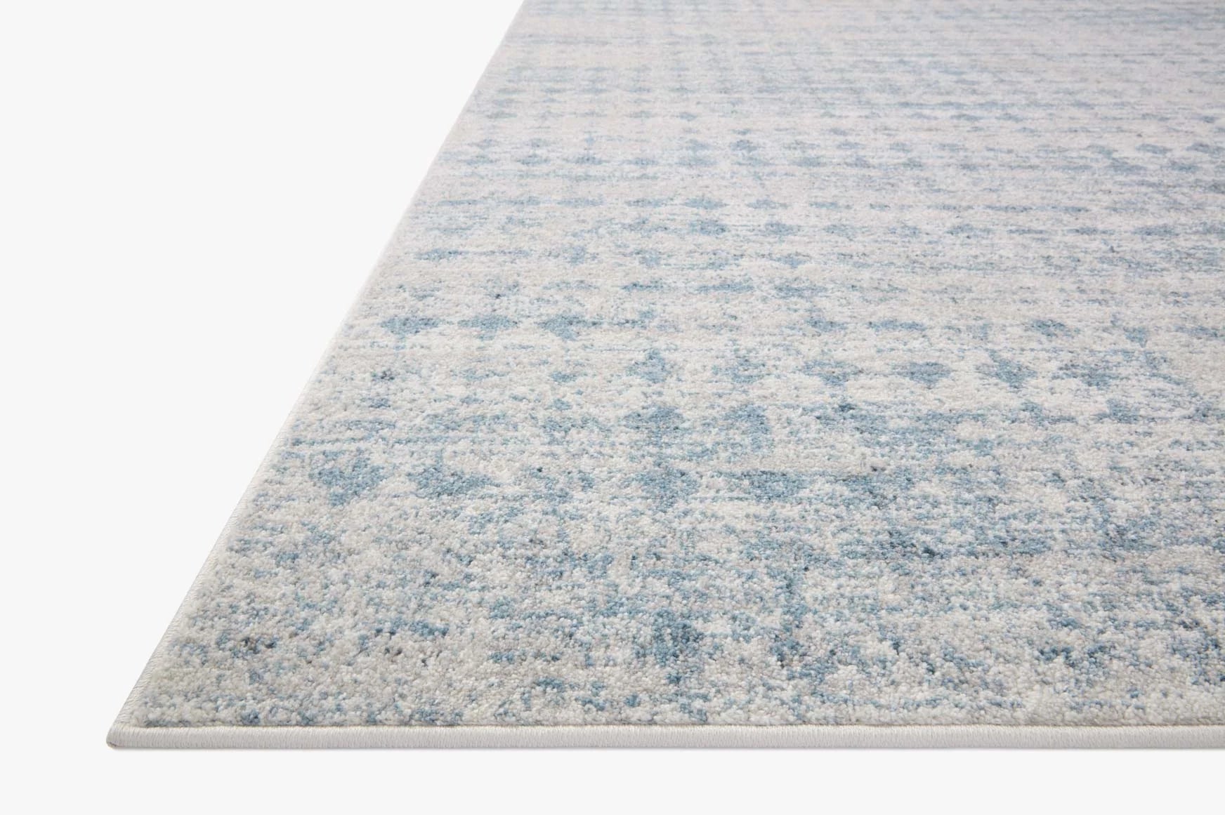 Light blue and off-white runner rug with textured abstract pattern and flat weave edge
