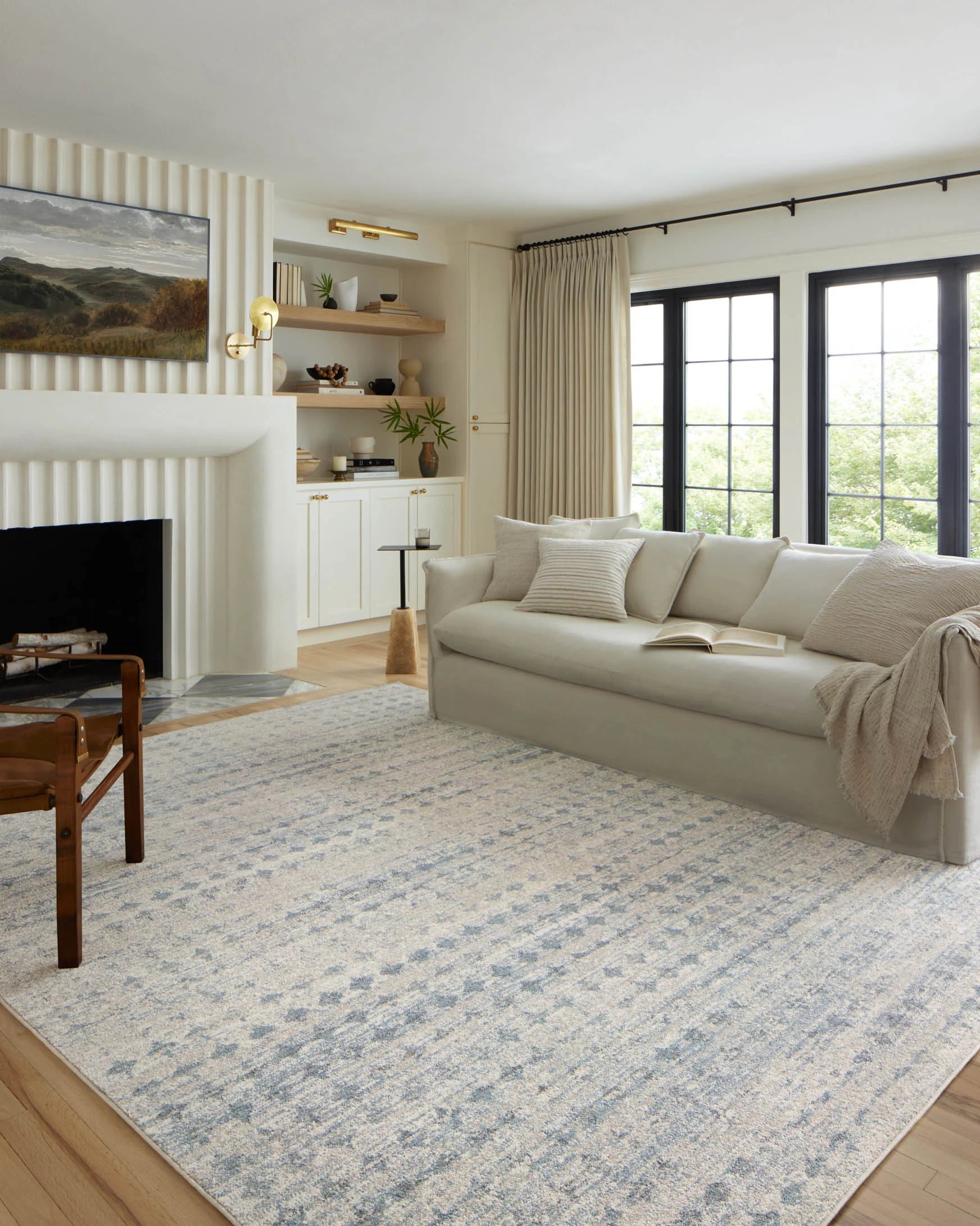 Sky-blue area rug with distressed texture, laid on light wood flooring
