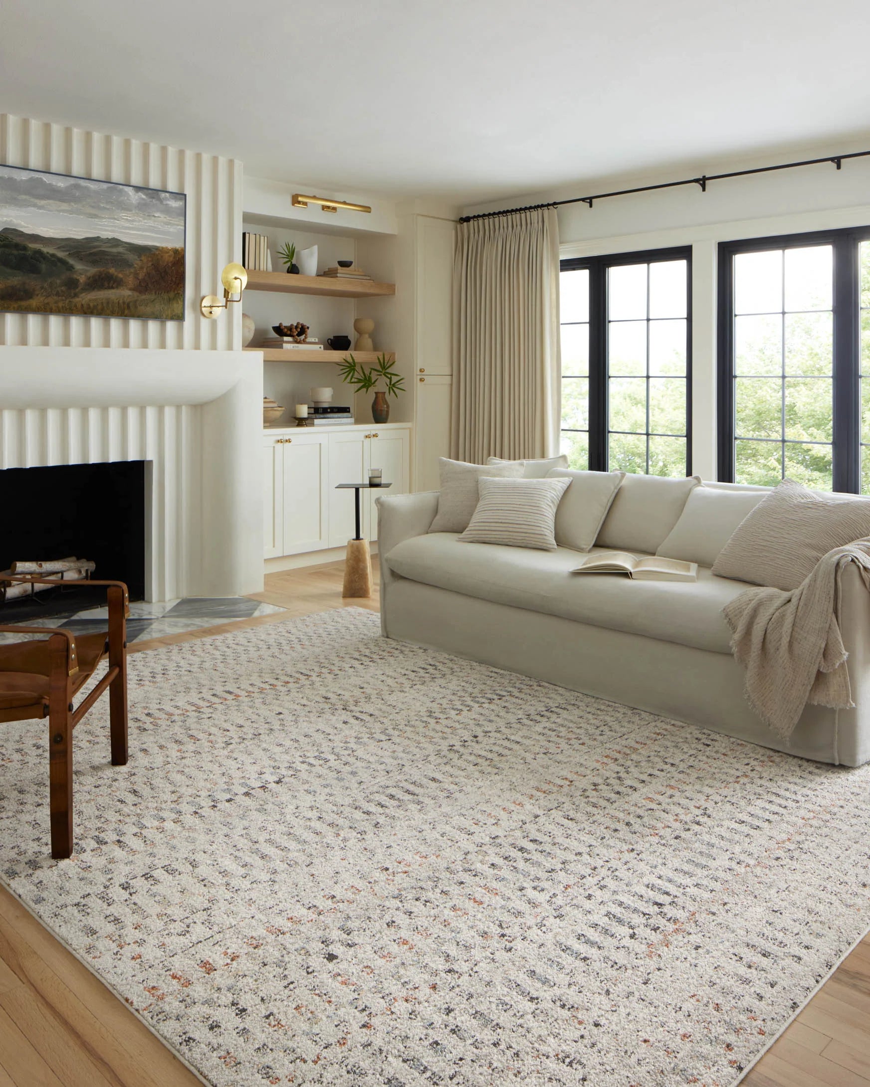 Grey transitional area rug with distressed geometric pattern in a living room