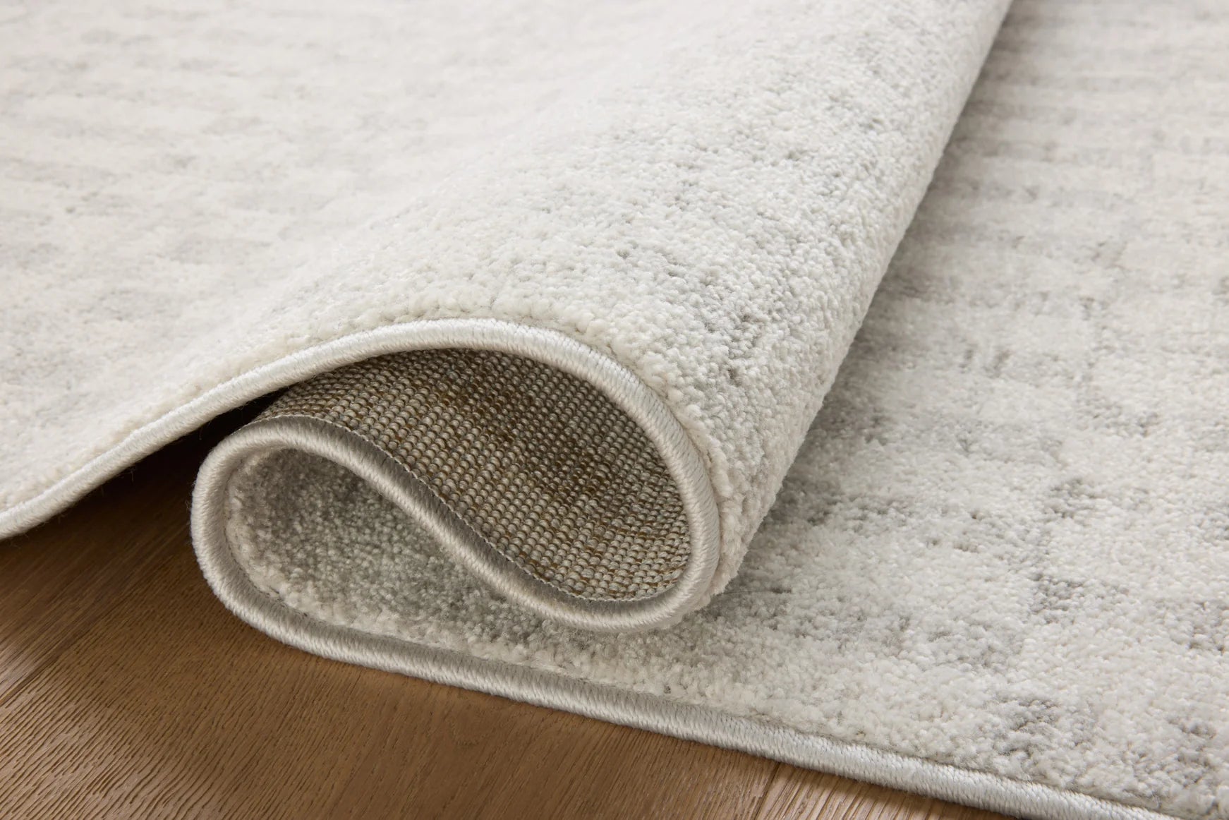 Ivory runner rug with grey edge binding and rolled pile detail