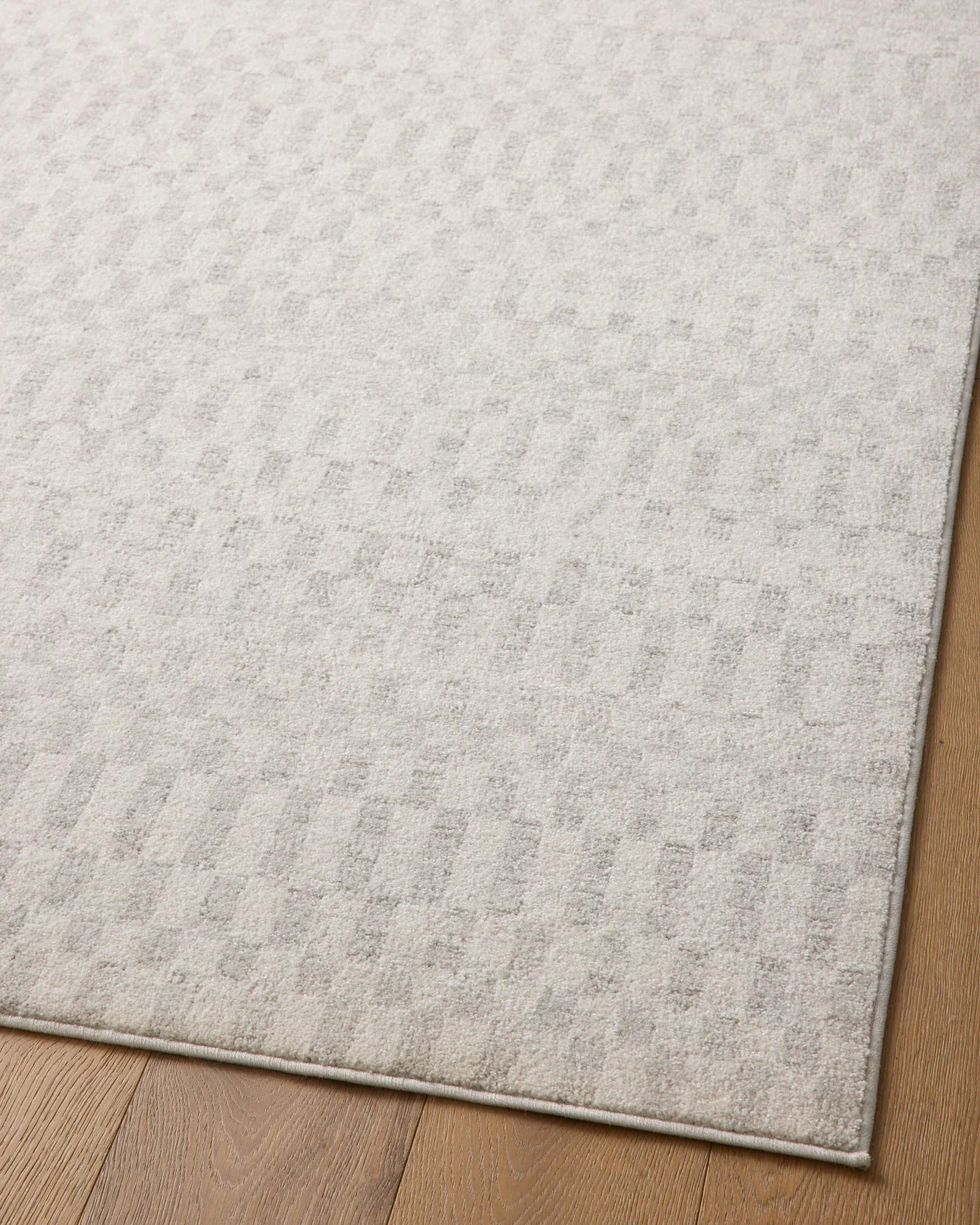 Ivory runner rug with textured geometric pattern and thin border