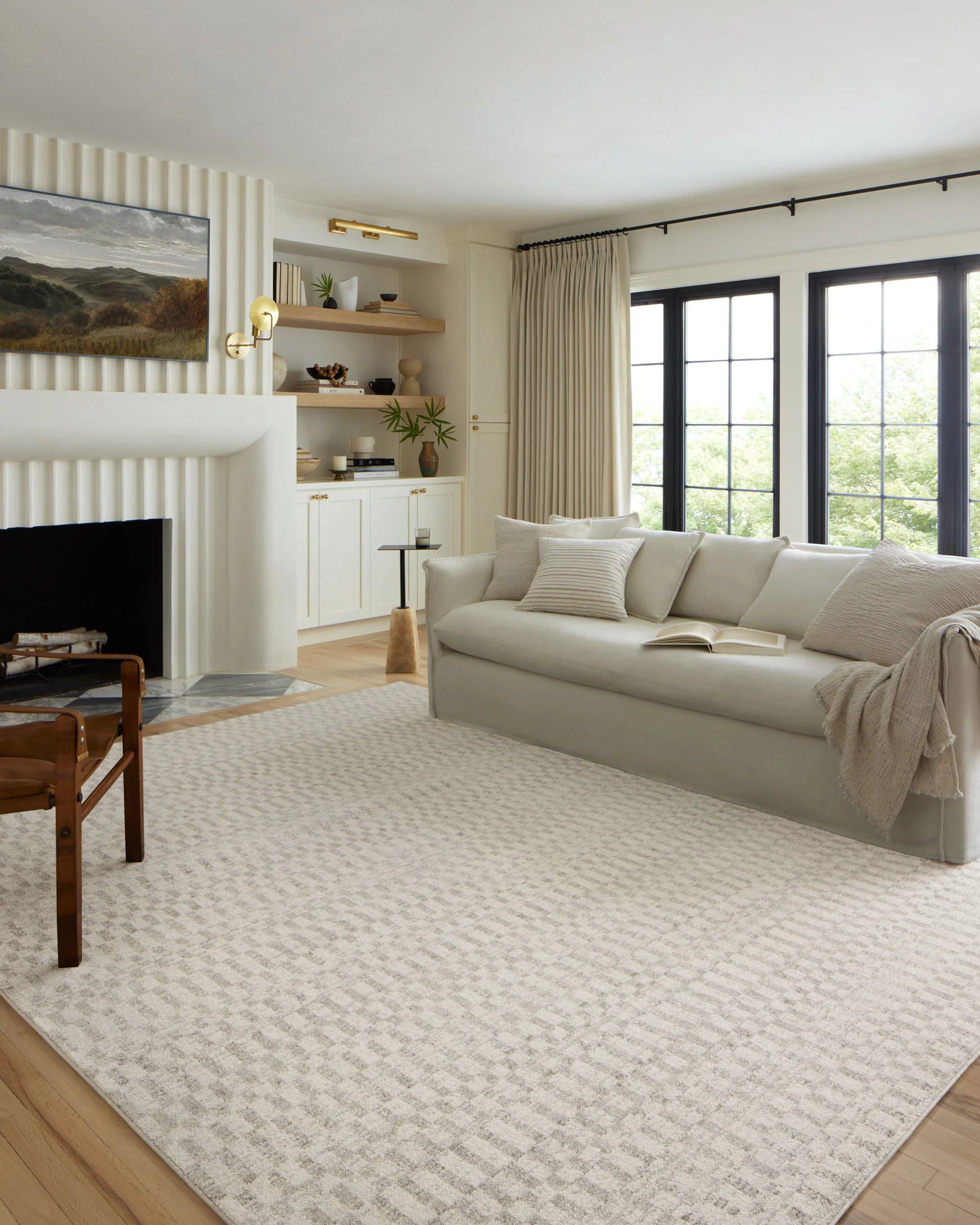 Ivory and grey area rug with repeating geometric motif on a low-pile surface