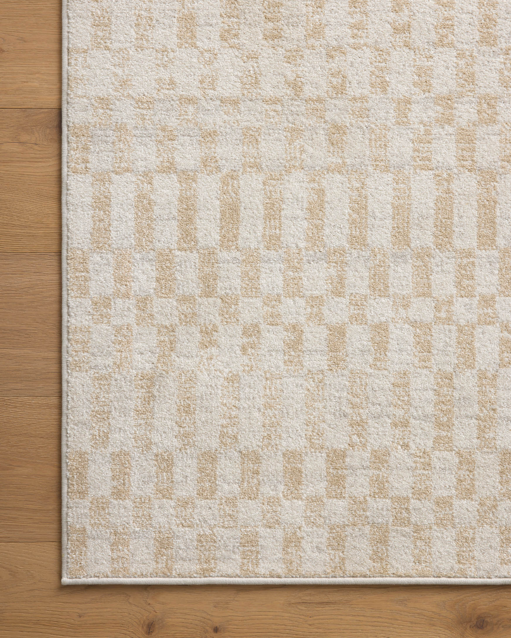 Ivory area rug with subtle check pattern and low-pile flatweave border.
