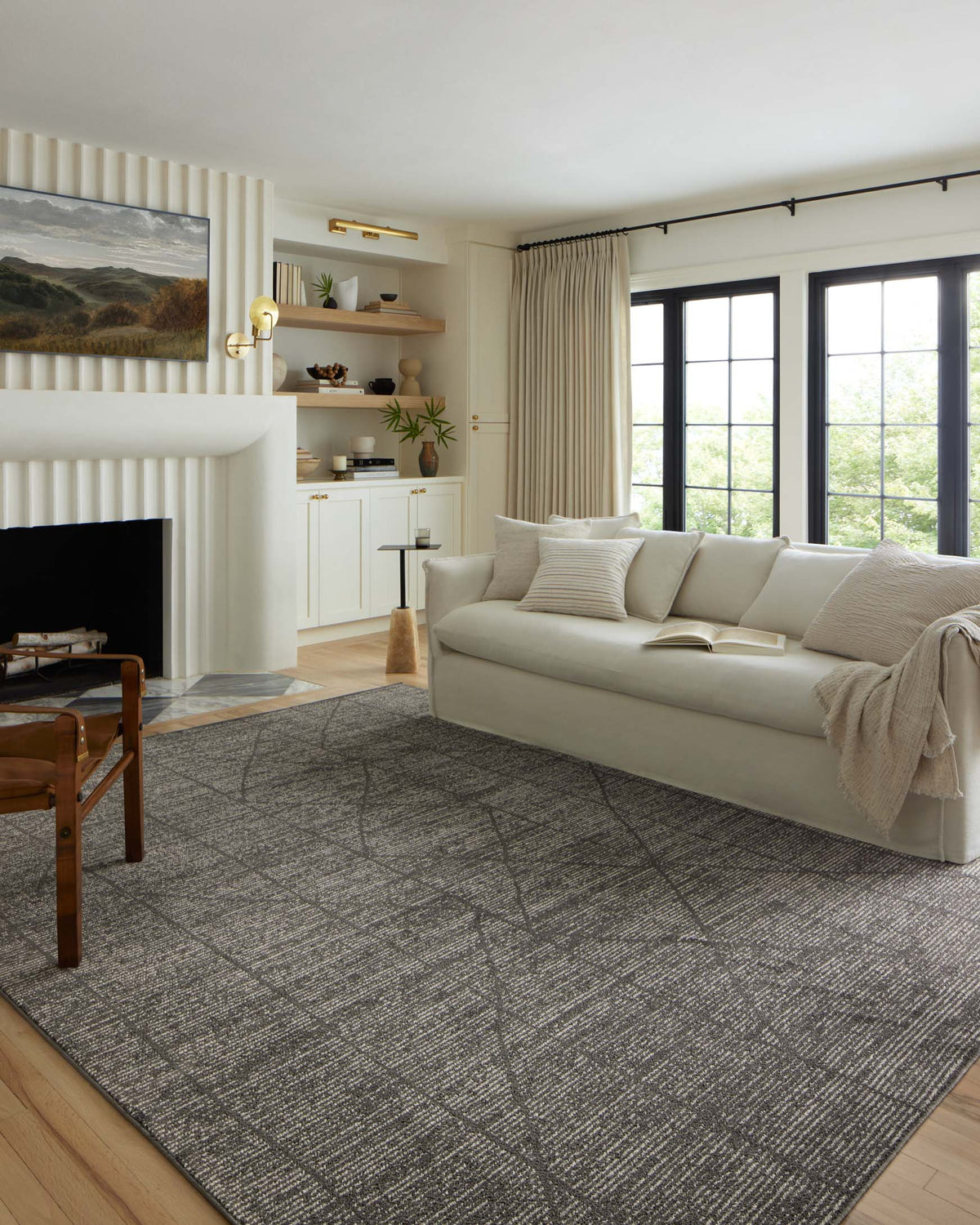 Charcoal area rug with ivory distressed geometric pattern