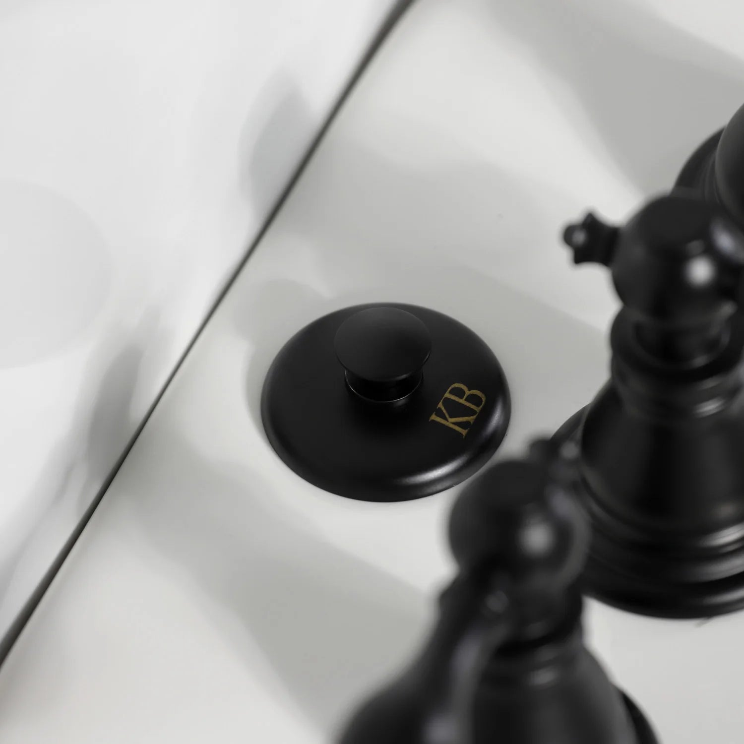 Matte black bidet faucet handle trim and round escutcheon on the rim