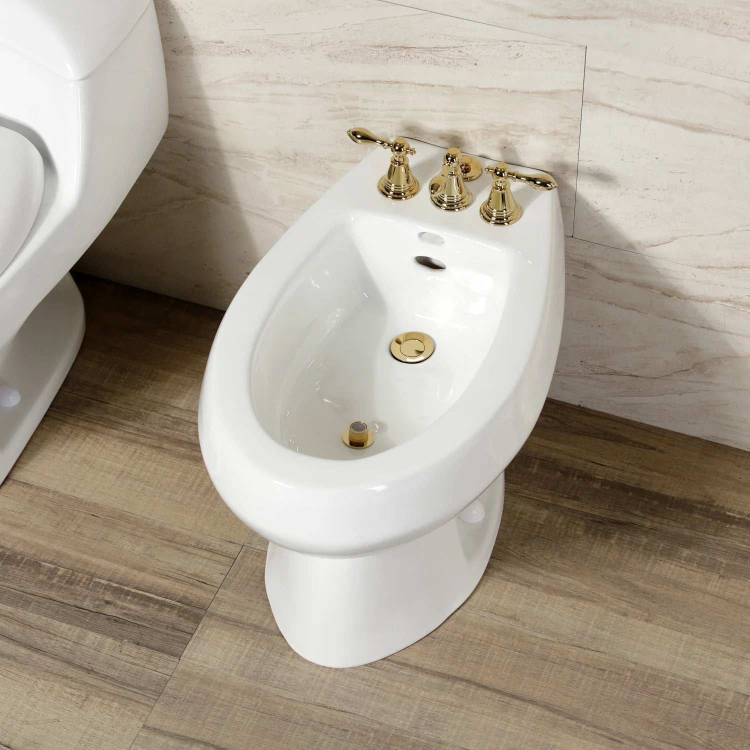 Polished brass three-handle bidet faucet on a white bidet toilet