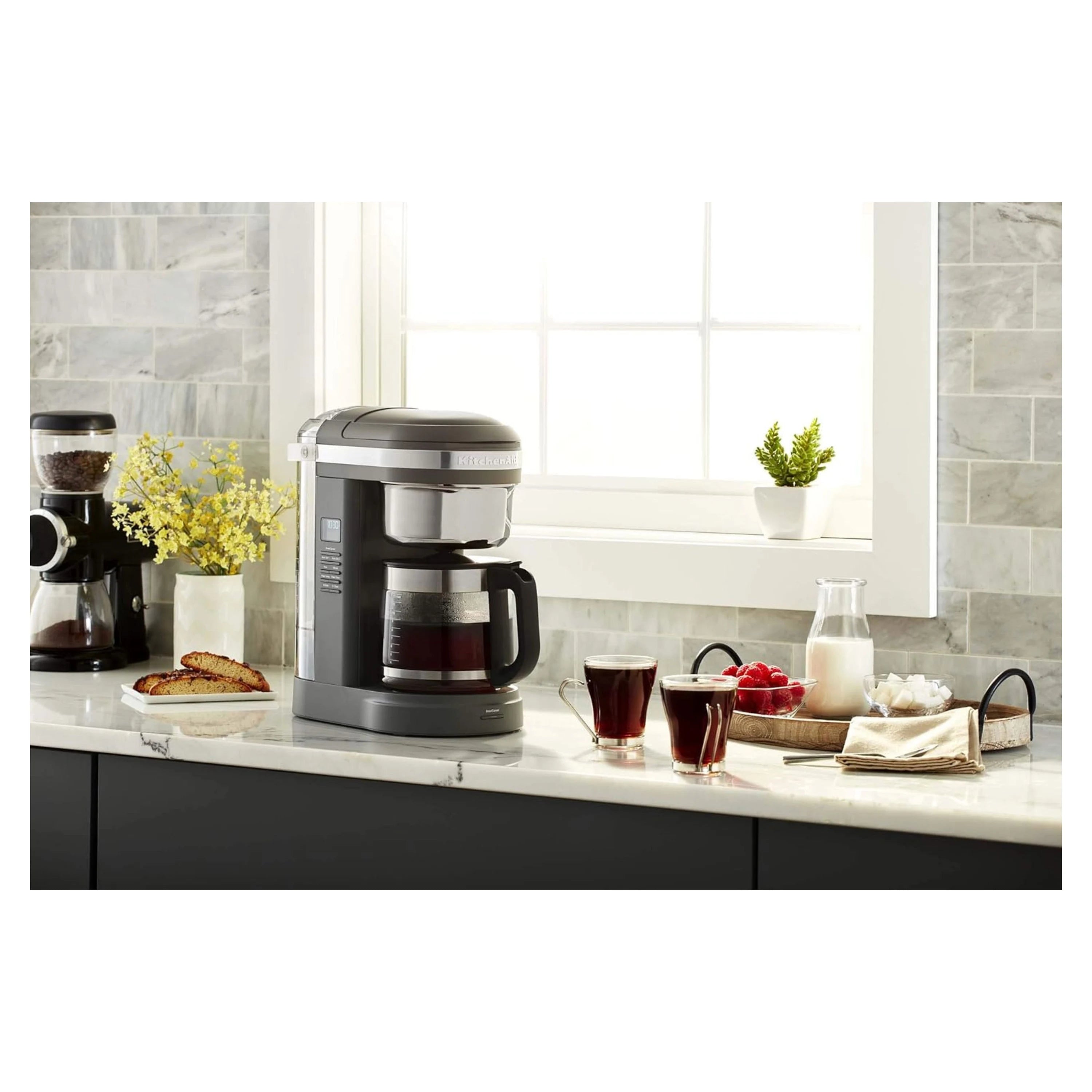 KitchenAid 12-cup drip coffee maker in matte charcoal gray with glass carafe and cups