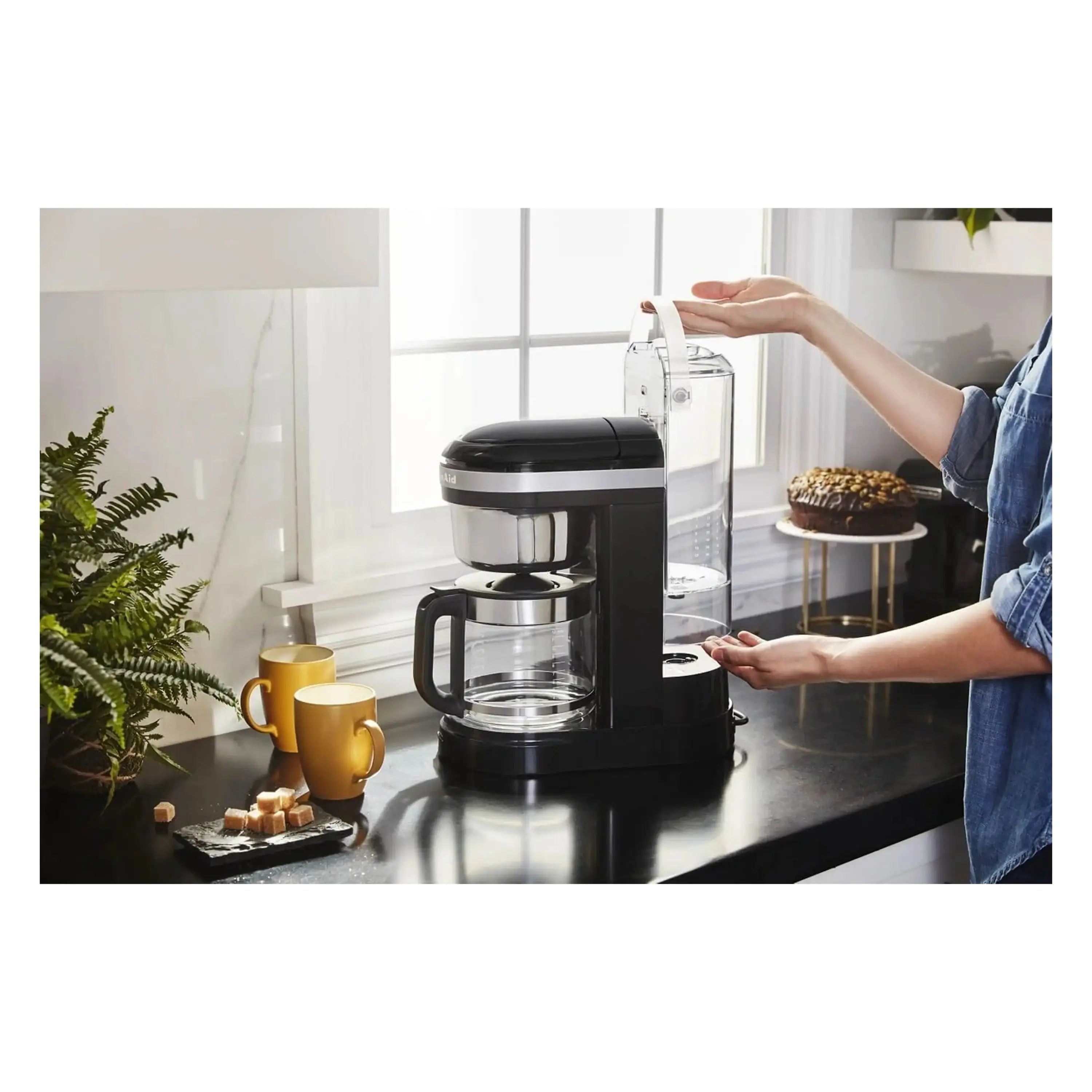 KitchenAid 12-cup drip coffee maker Onyx black with carafe and pouring hand