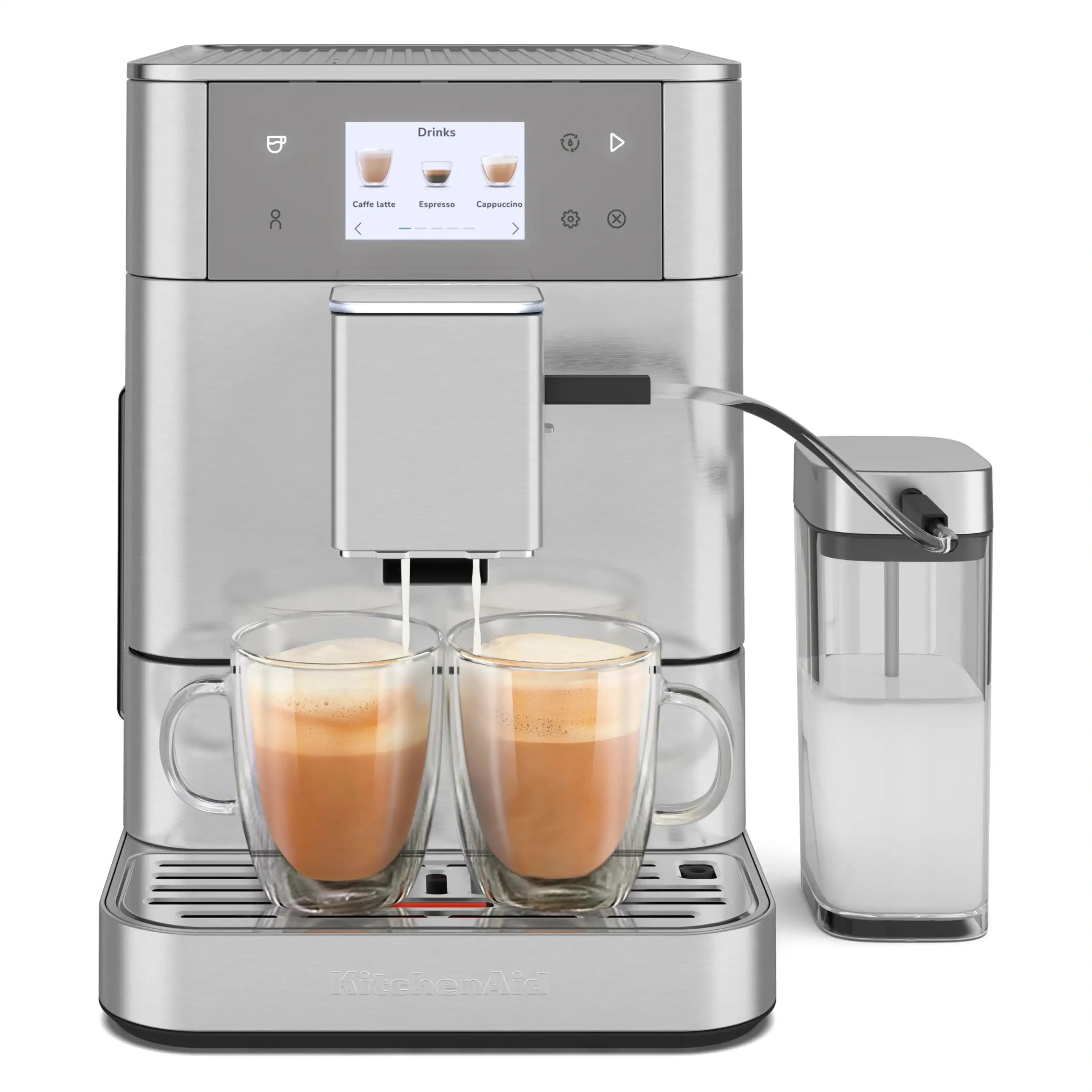Stainless steel espresso machine dispensing milk drinks into two clear mugs