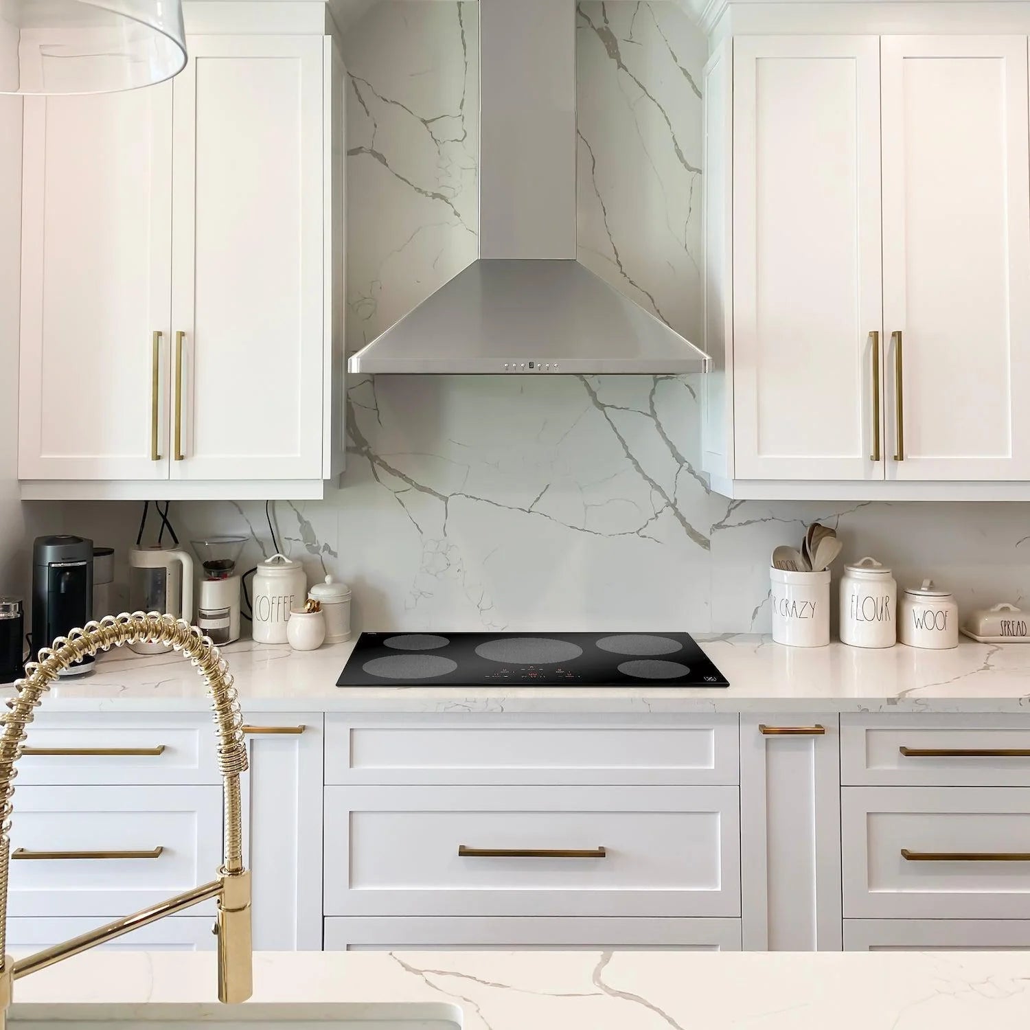 Undercounter induction cooktop installed in a white kitchen with five burner zones