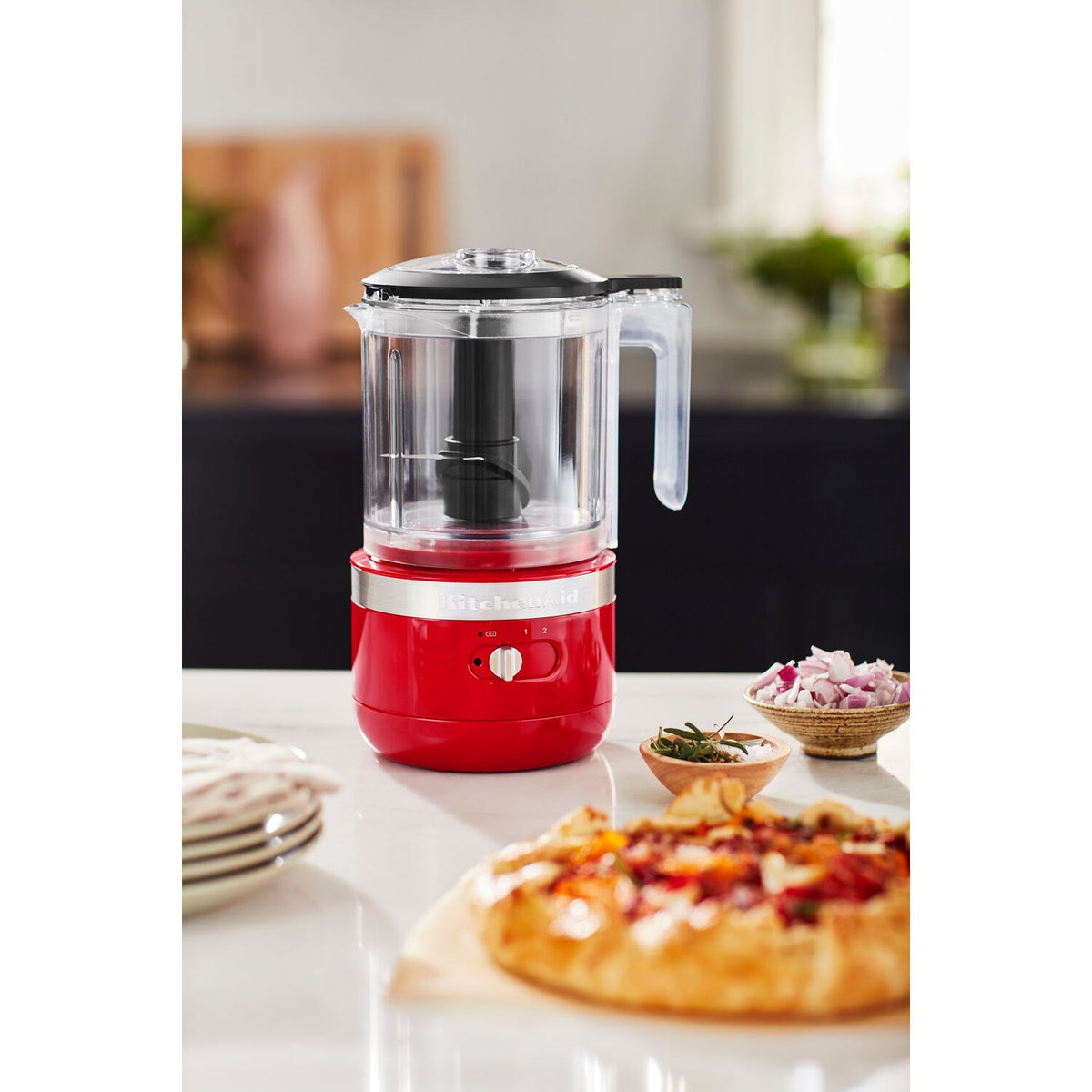 Passion red food chopper with clear processing bowl and stainless blade, countertop use
