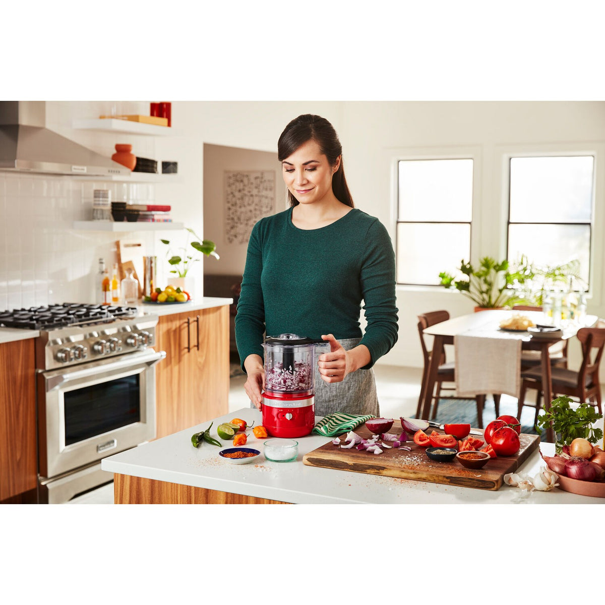 Passion red 5-cup food chopper on countertop with clear bowl and blade