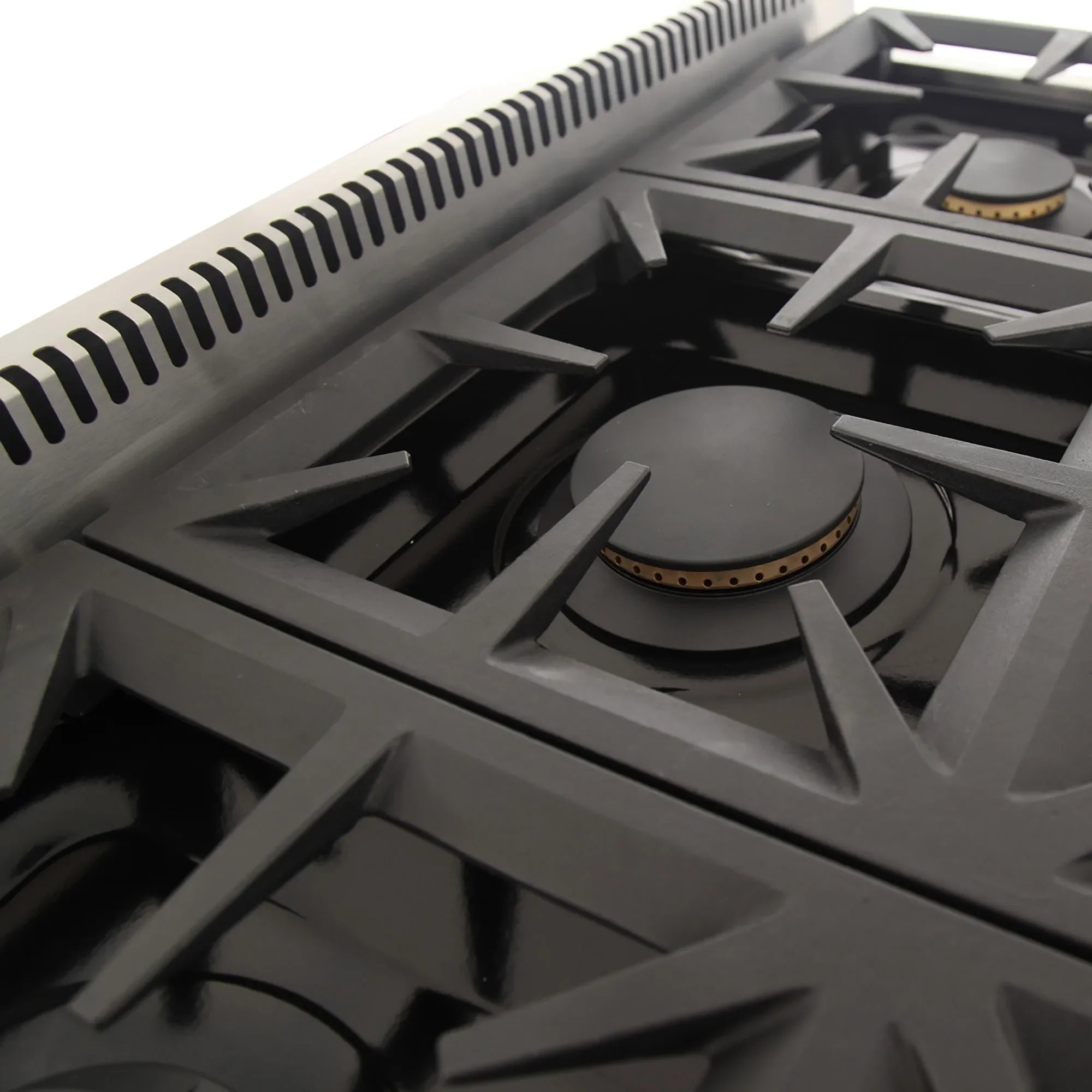 Gas range burner with black cap and brass-colored ring detail