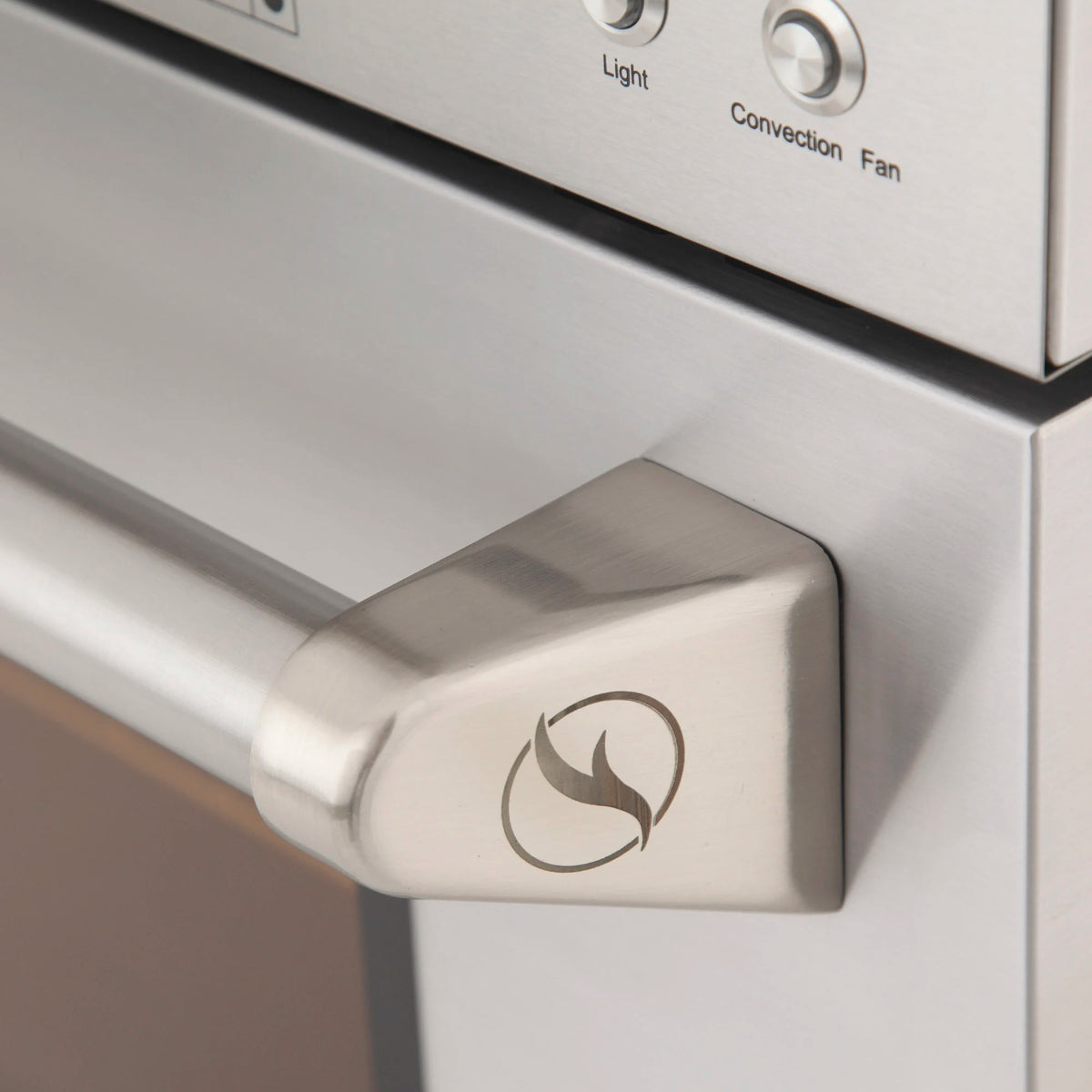 Silver oven control knob with flame icon on olive gas range