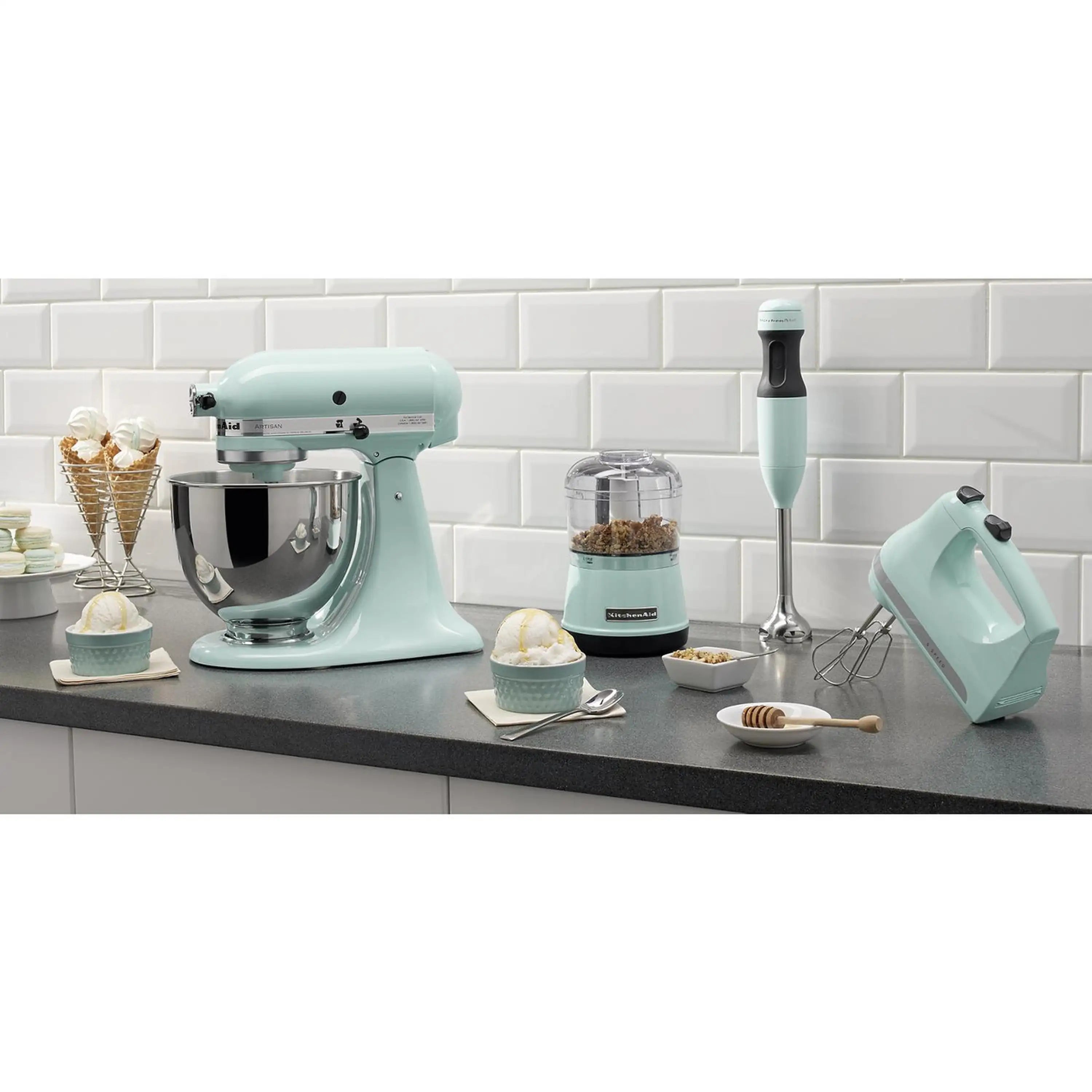 Ice-colored KitchenAid stand mixer and matching hand mixer with beaters on kitchen counter
