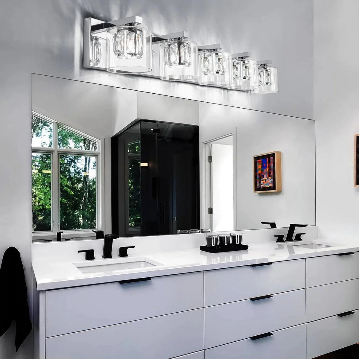 Chrome 5-light vanity light bar above double sink, clear glass shades on backplate.