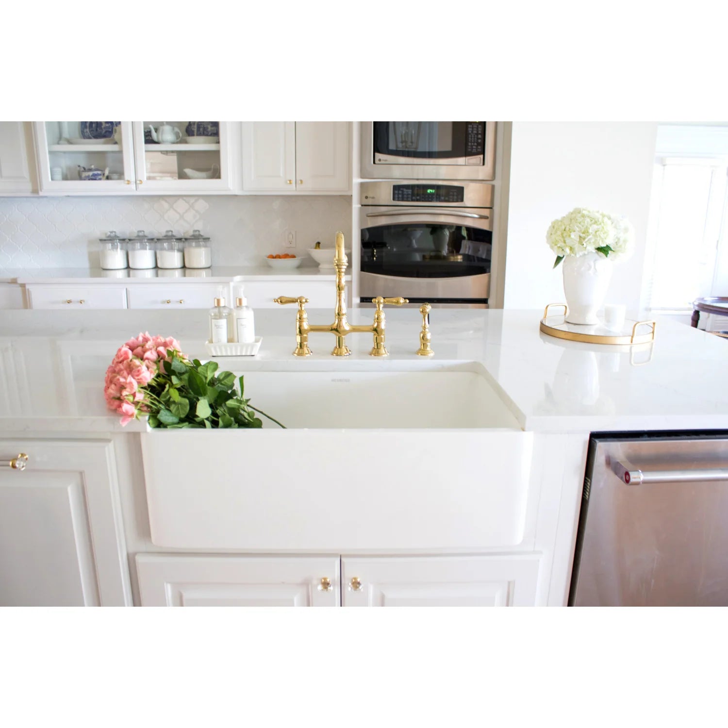 Polished brass bridge kitchen faucet with cross handles and side sprayer