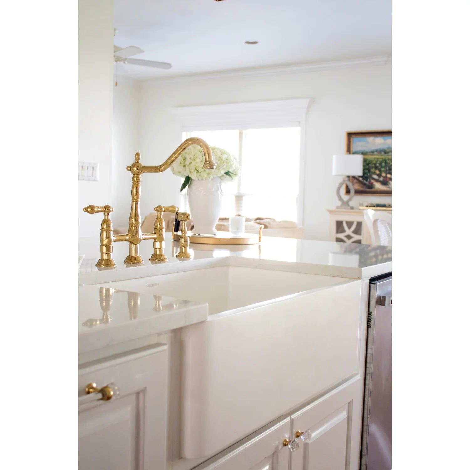 Polished brass bridge faucet with cross handles and curved spout