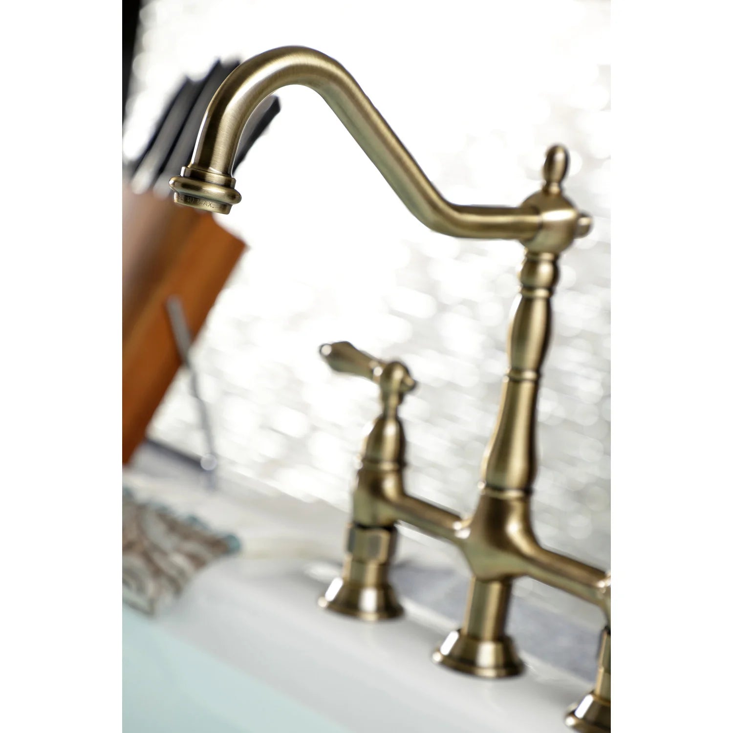 Antique brass gooseneck spout with center handle on bridge kitchen faucet