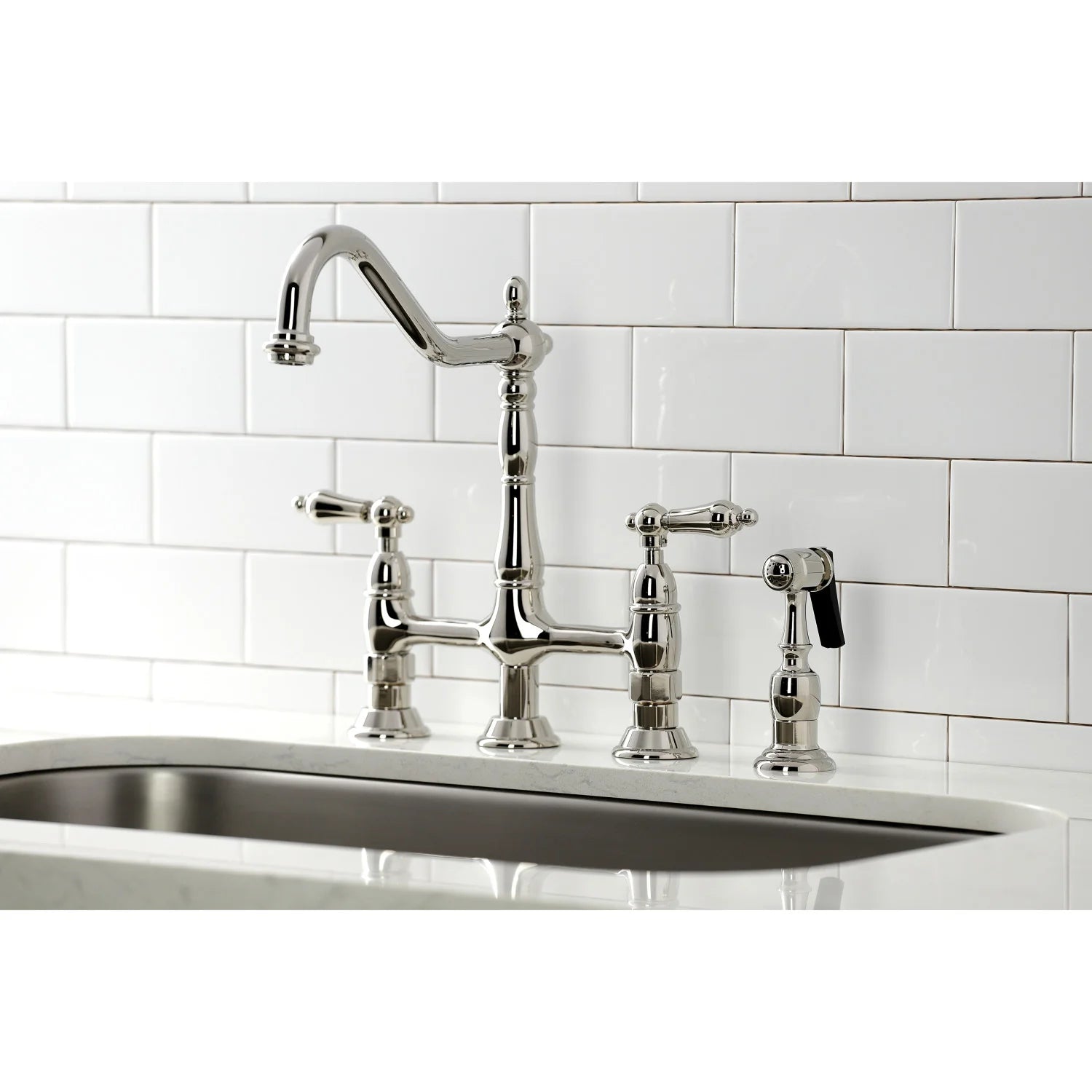 Polished nickel bridge kitchen faucet with high-arc spout, handles, and side sprayer