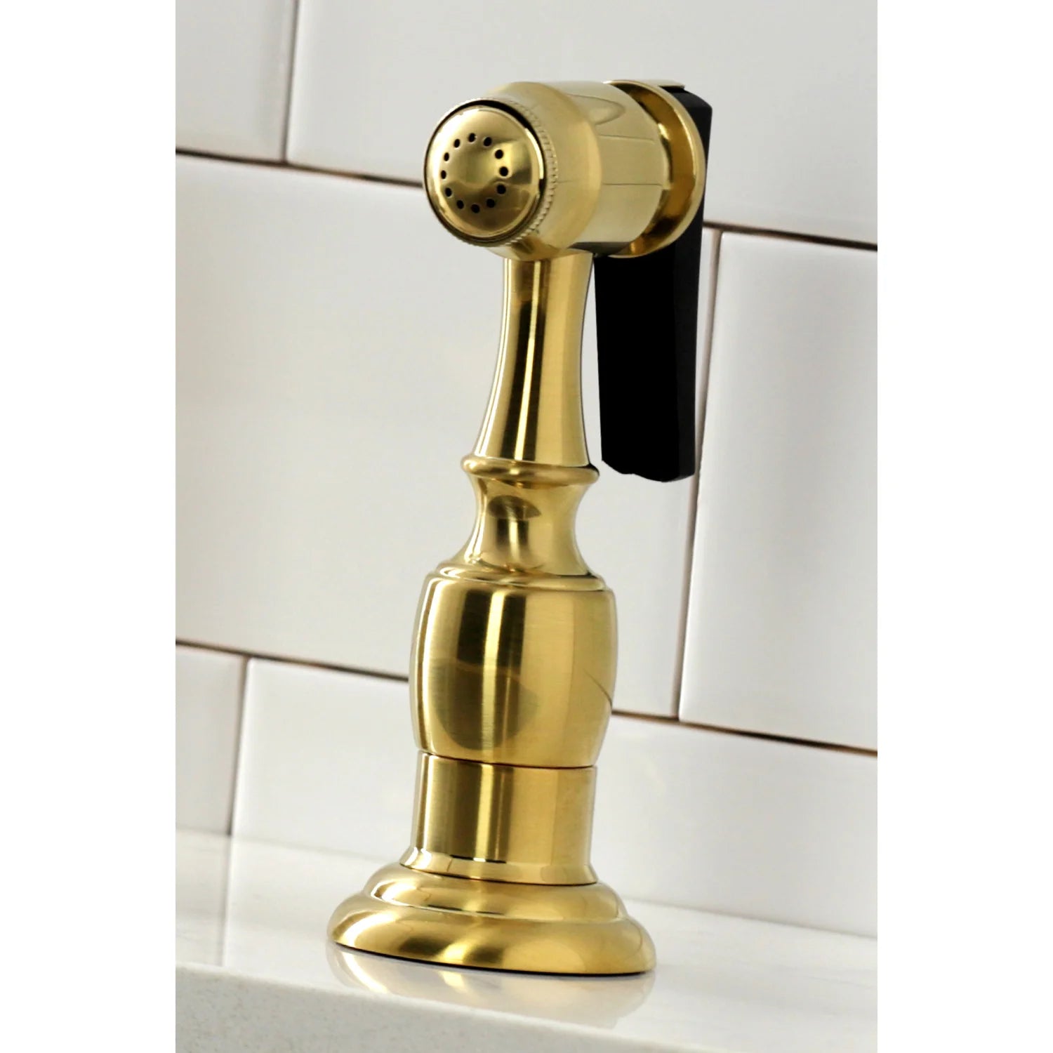 Close-up of brushed brass side sprayer with spray head and lever