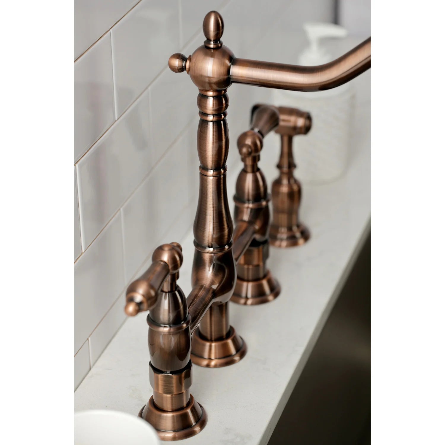 Antique copper faucet body detail with arched spout and side sprayer lever