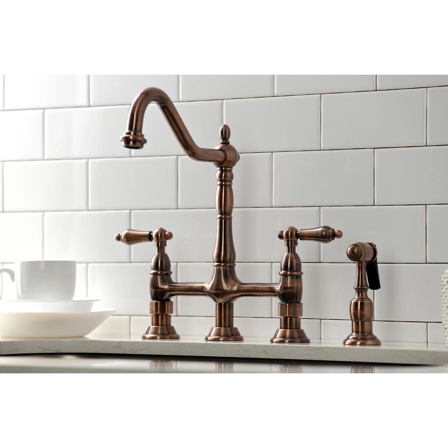 Antique copper bridge kitchen faucet with arched spout, side sprayer, and lever handles