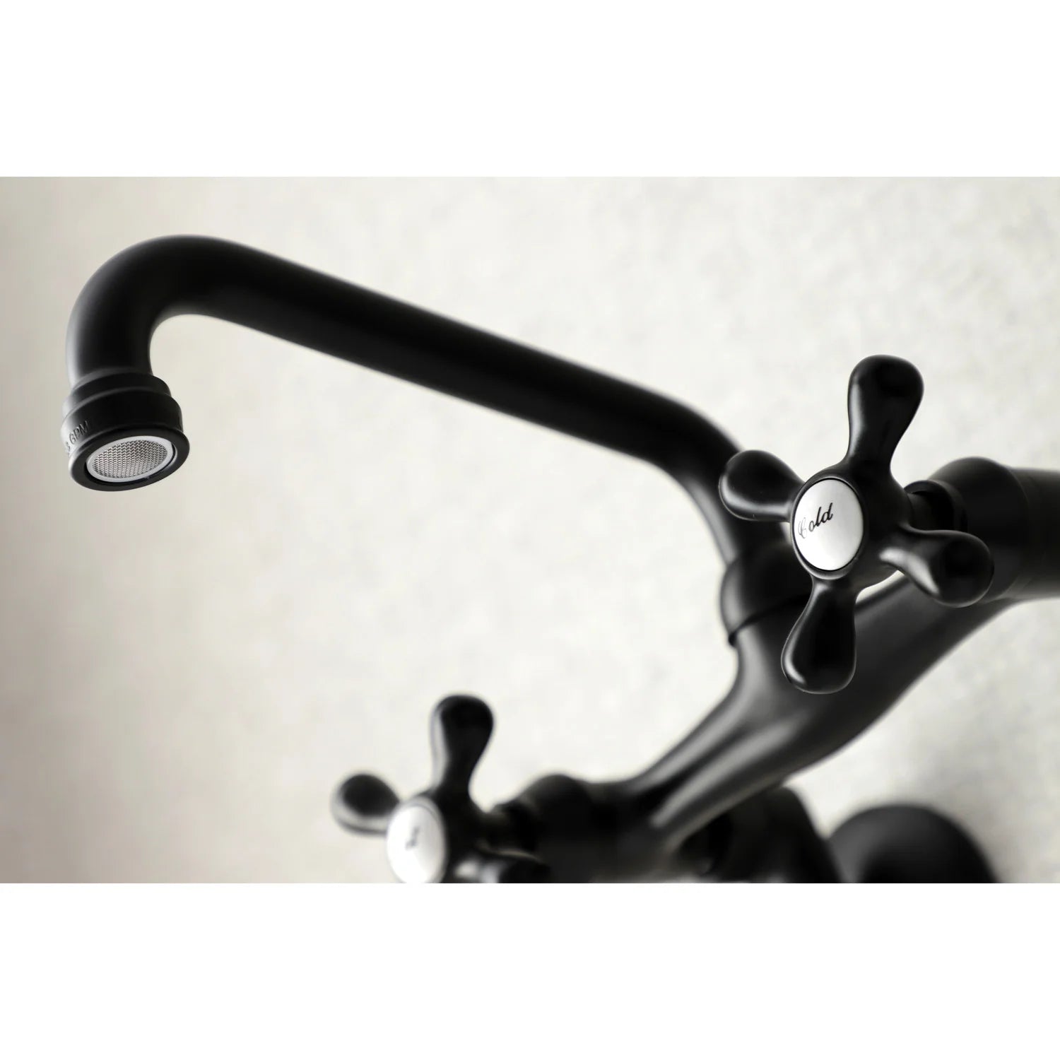 Matte black arched spout with aerator and hot/cold cross-handle controls