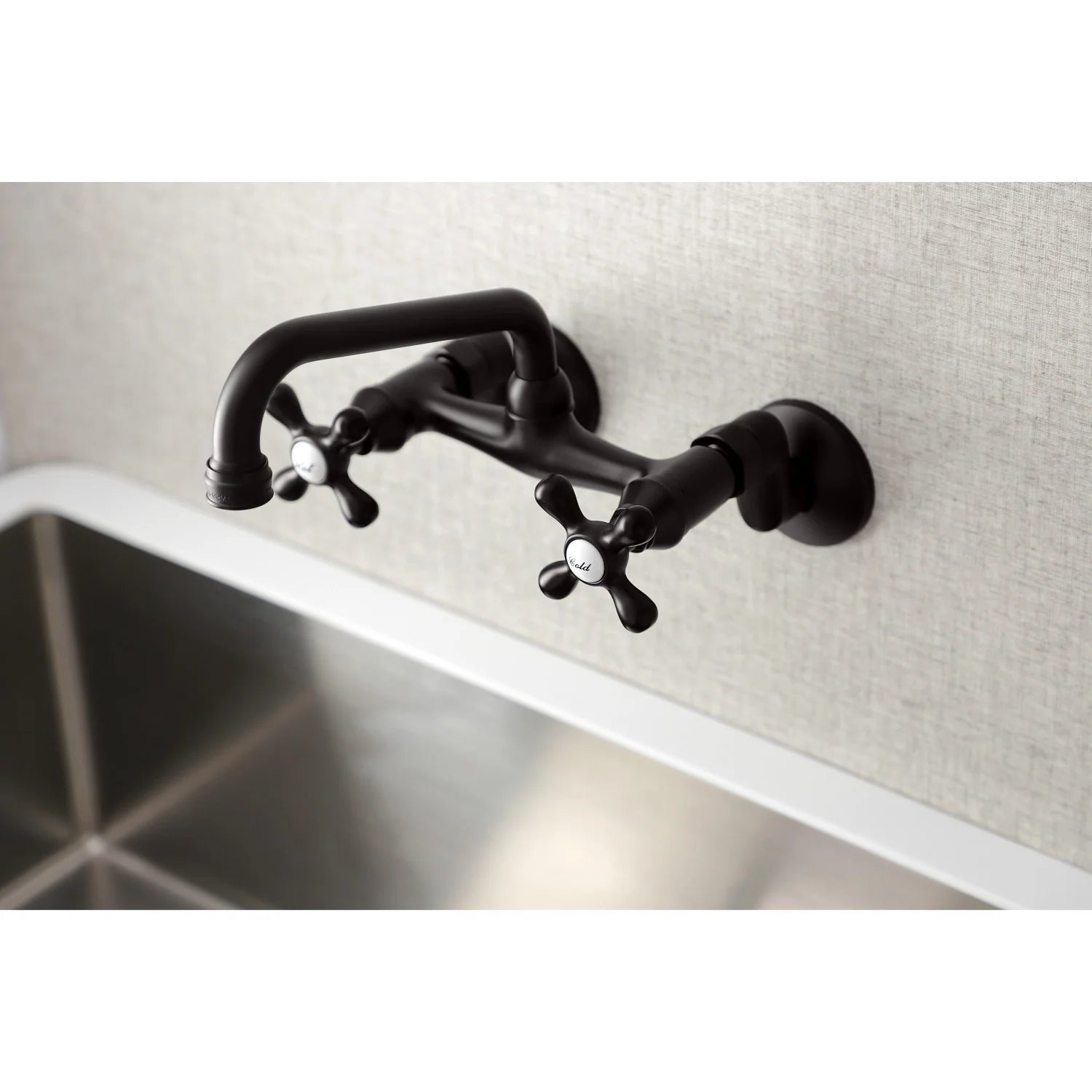 Oil-rubbed bronze bridge kitchen faucet installed on wall with double handles and curved spout