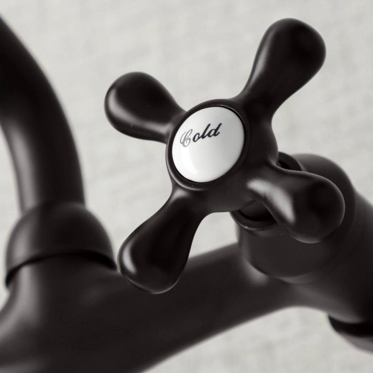 Oil-rubbed bronze double handle faucet detail with hot and cold indicator buttons