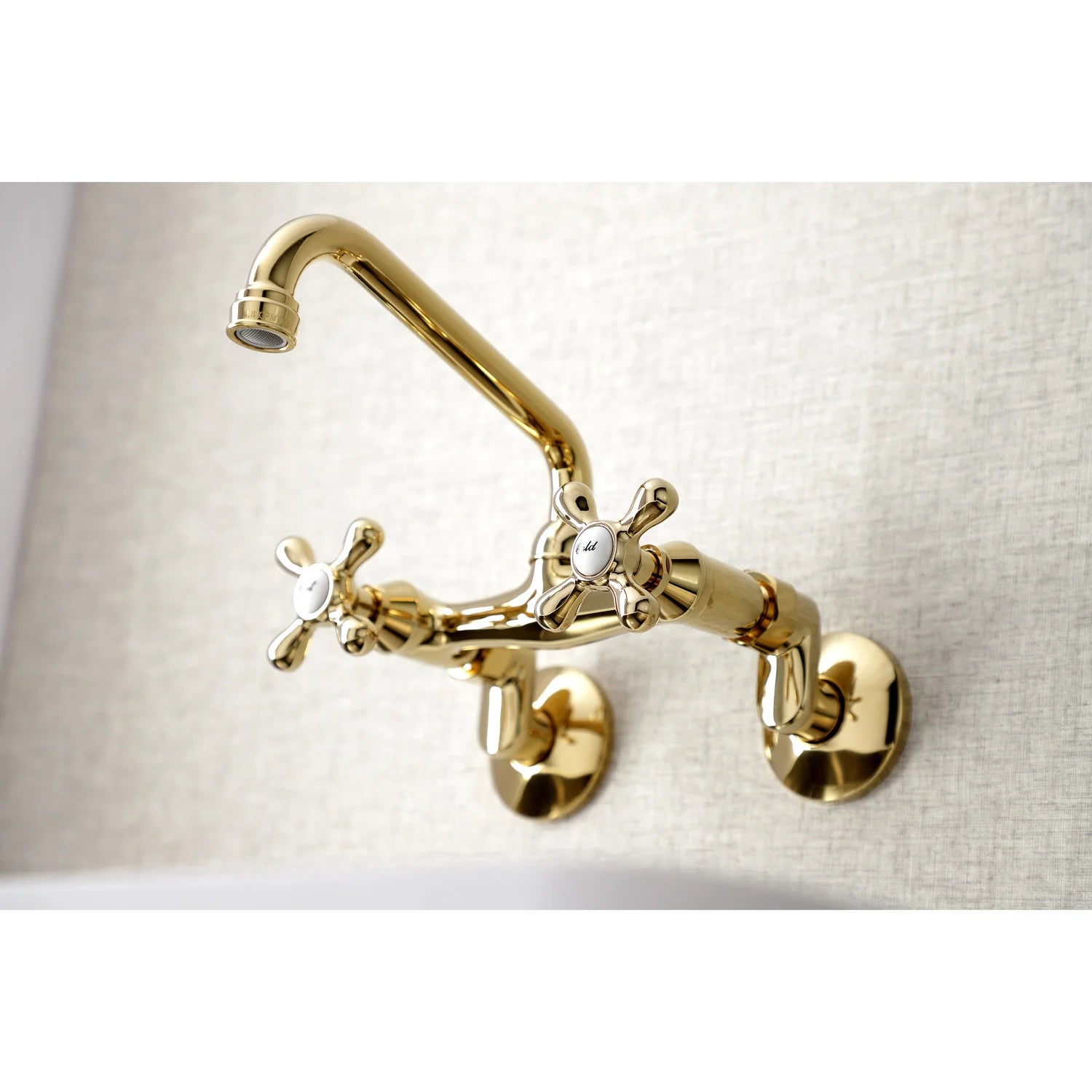 Polished brass bridge faucet with raised spout and two cross handles on wall plate