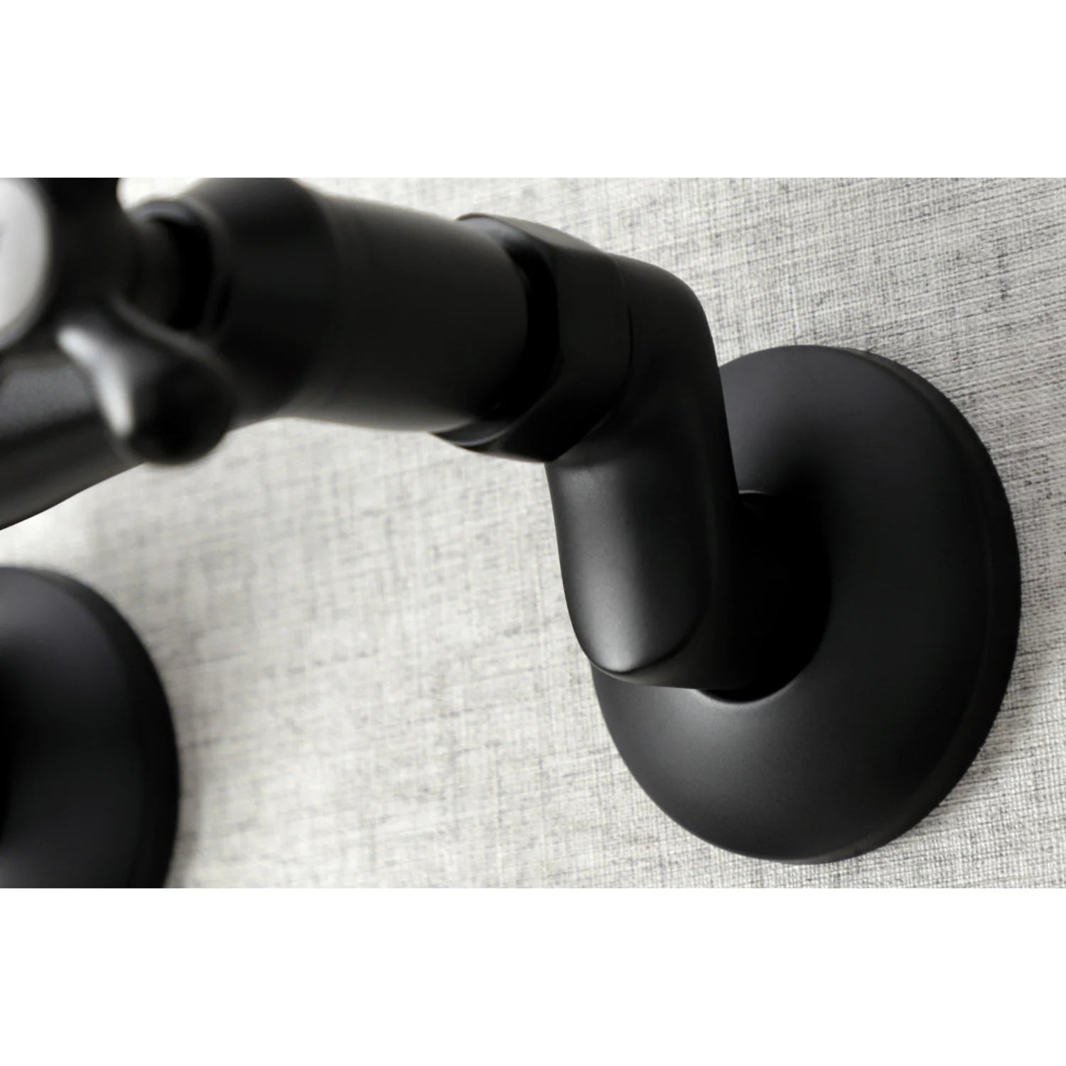 Matte black wall-mount faucet base and underside mounting on wall