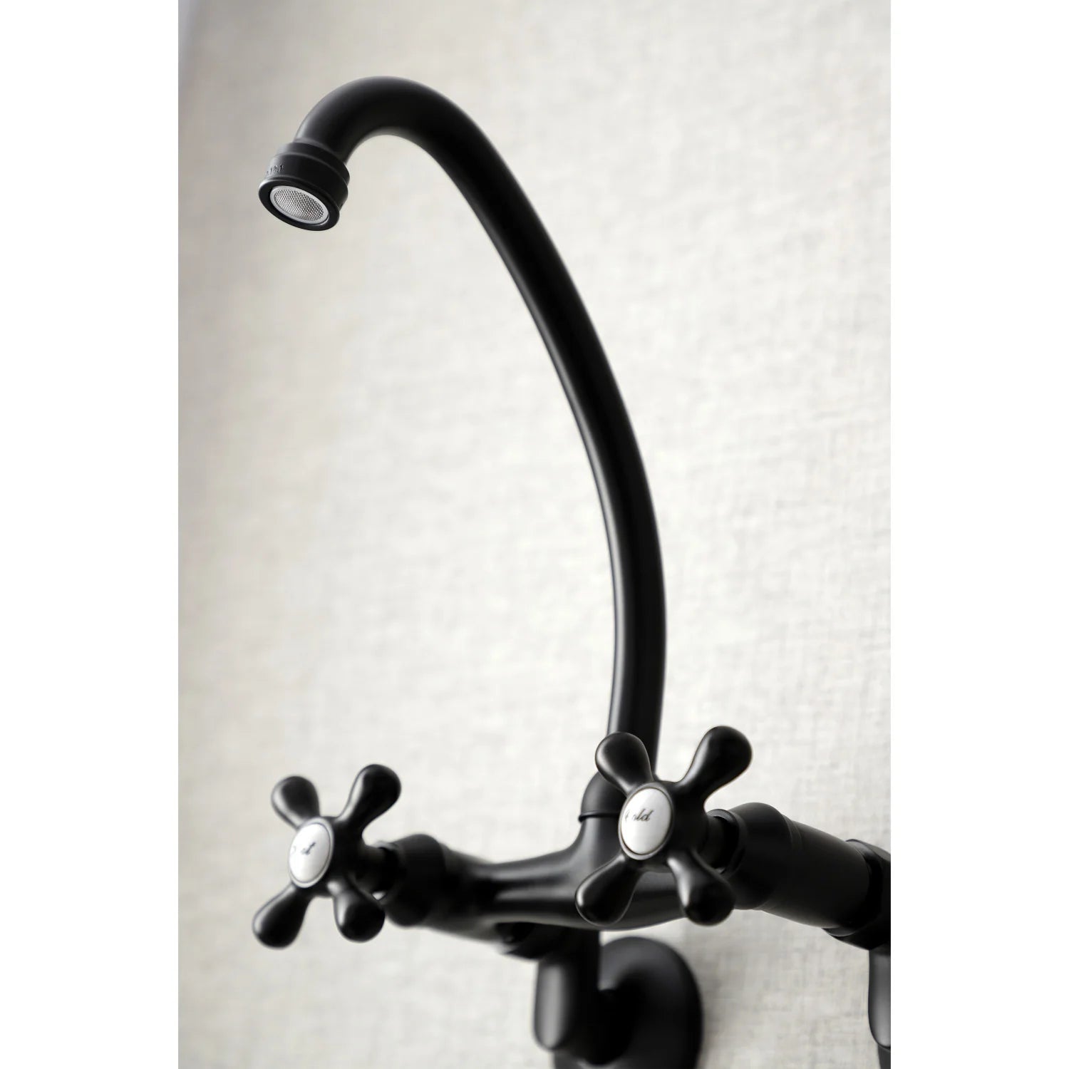 Matte black curved kitchen faucet spout with double cross-handle controls