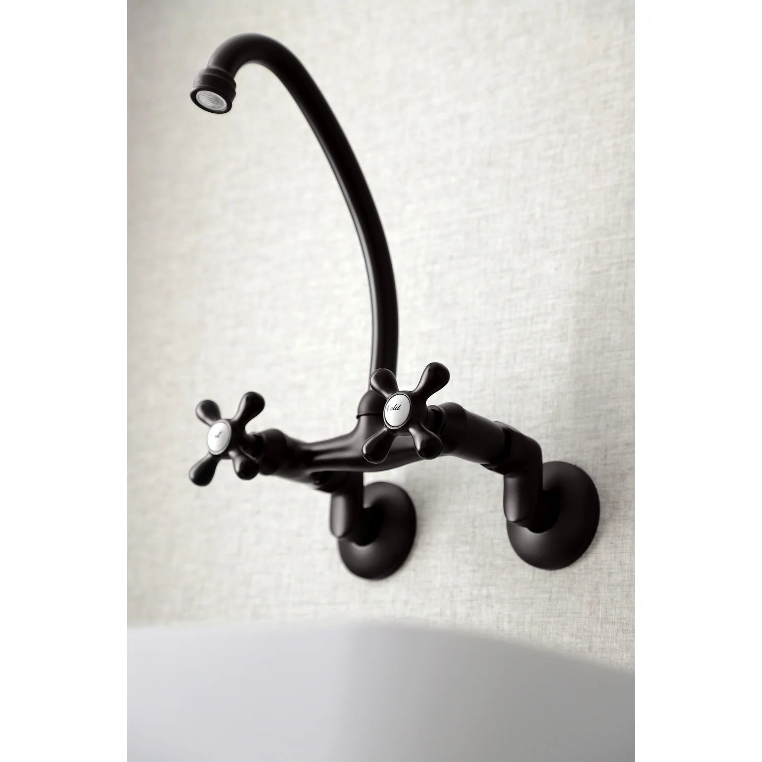 Oil-rubbed bronze bridge kitchen faucet with curved spout and cross-style hot and cold handles