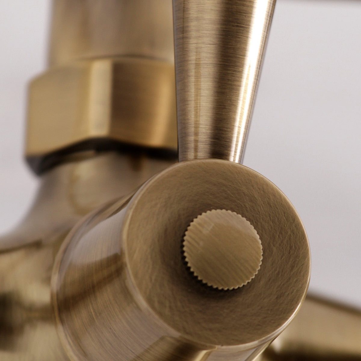 Kingston Wall Mount Clawfoot Tub Faucet with Hand Shower in Antique Brass
