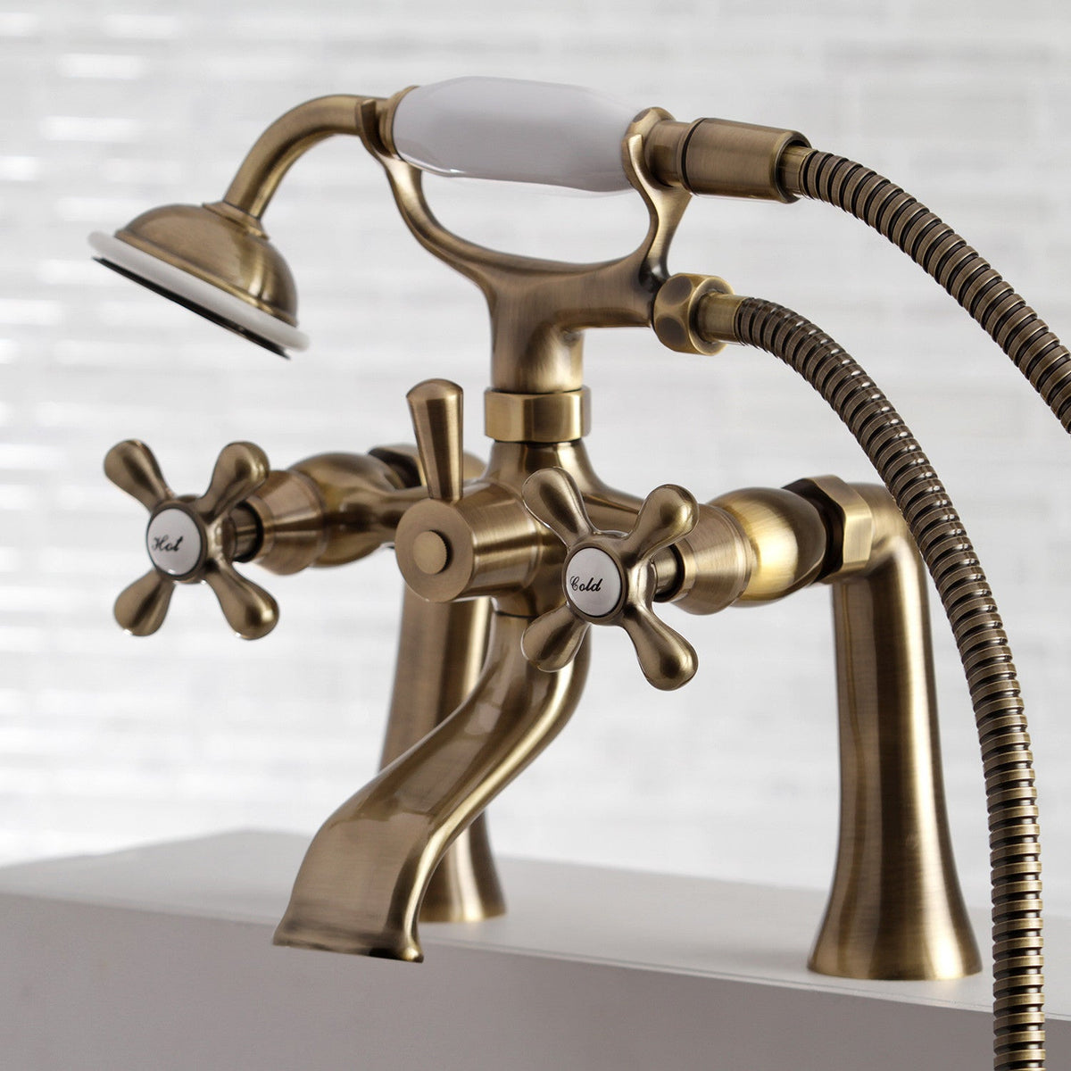 Kingston 7" Center Deck-Mount Clawfoot Tub Faucet with Hand Shower in Antique Brass