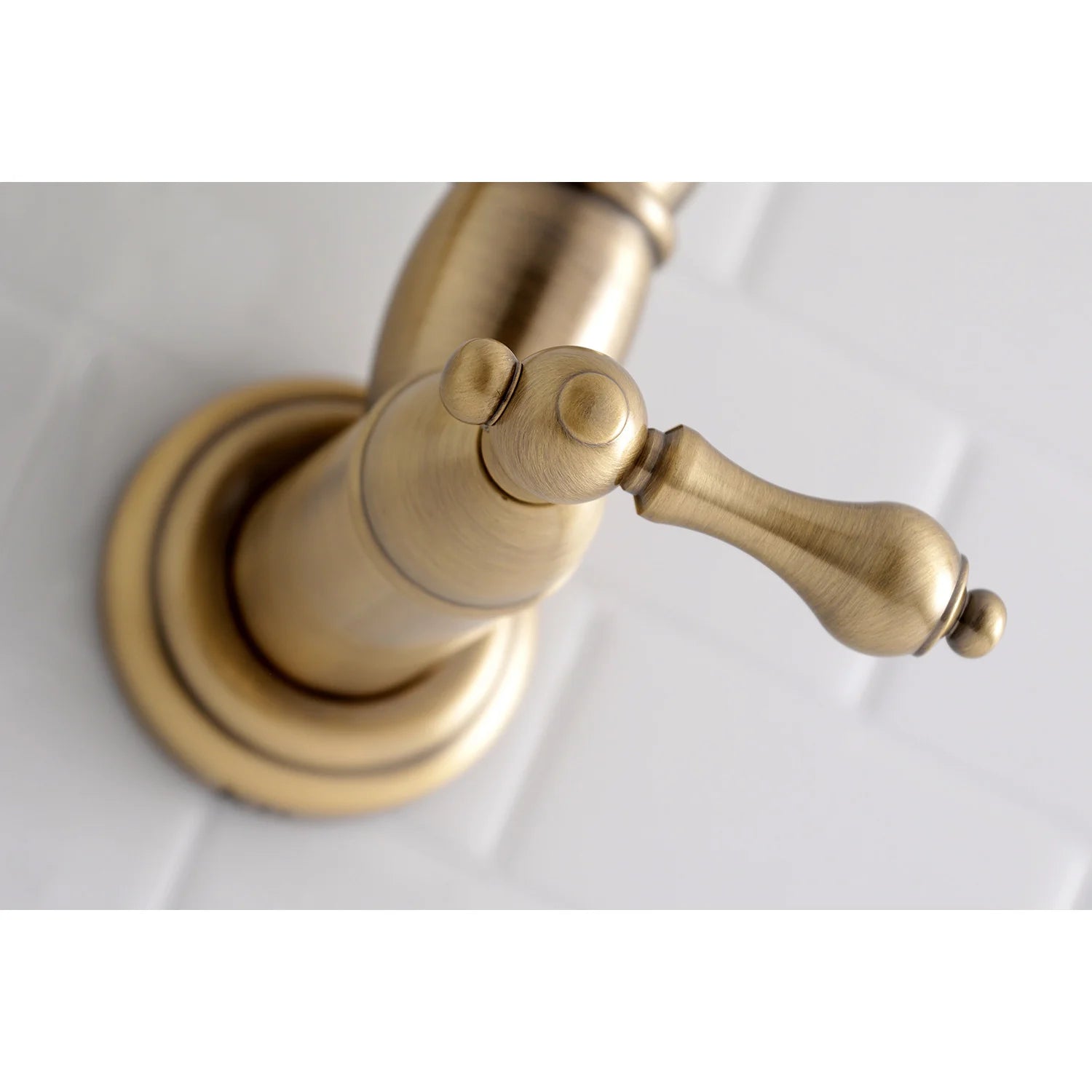 Antique brass close-up of pot filler spout and lever handles