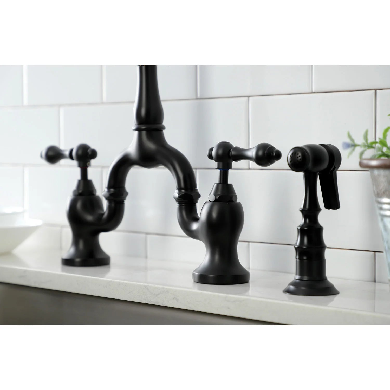 Matte black bridge kitchen faucet with deck controls and side sprayer