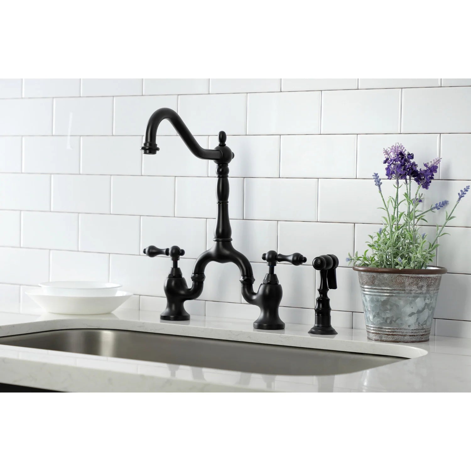 Matte black bridge kitchen faucet with side sprayer and matching deck-mounted handles