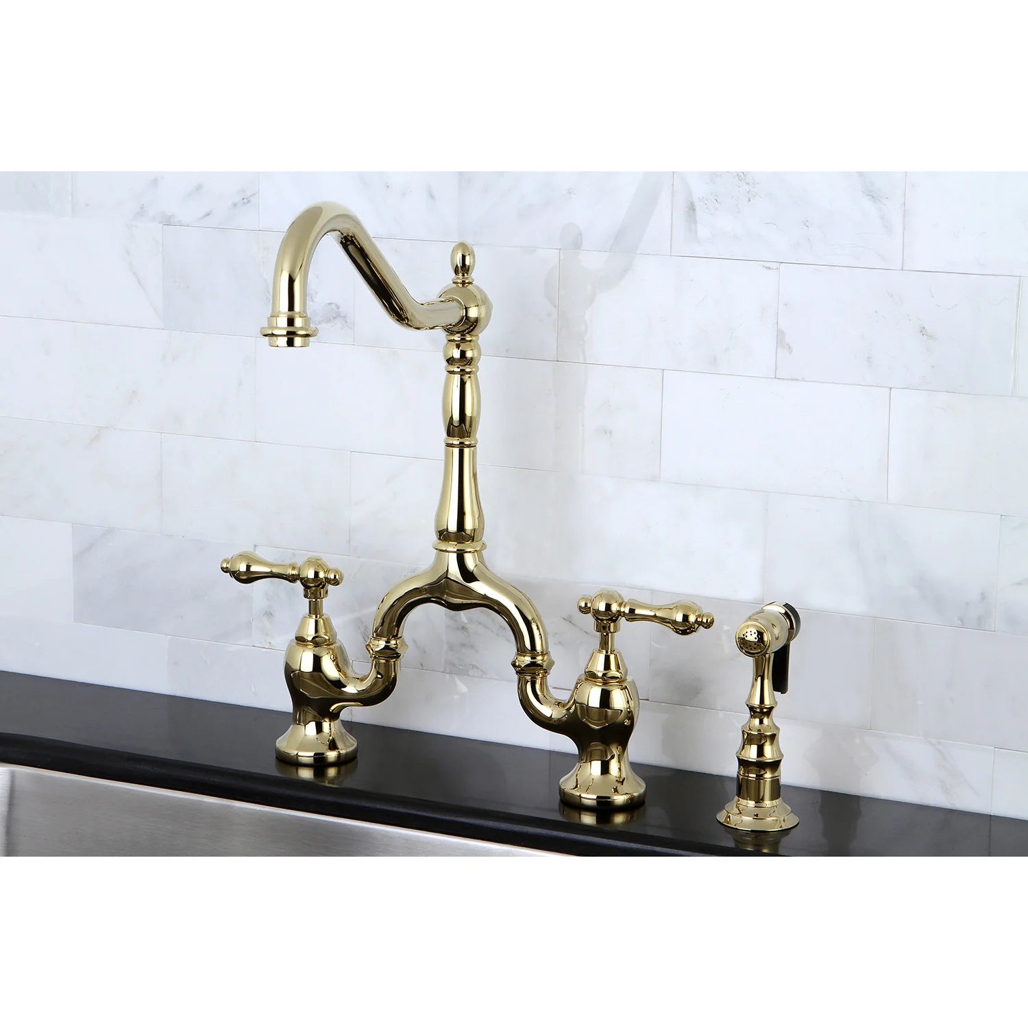 Polished brass bridge kitchen faucet with curved spout and side sprayer, mounted