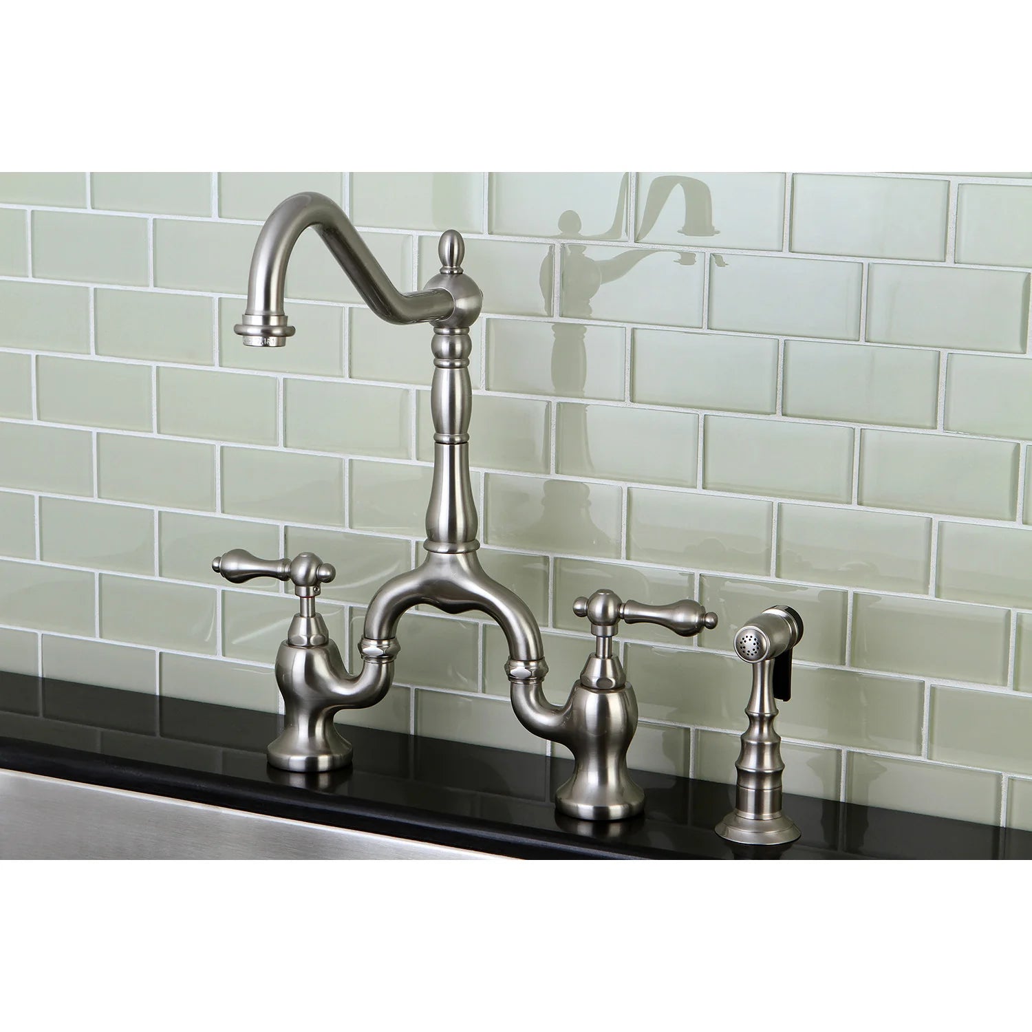 Brushed nickel bridge kitchen faucet with side sprayer and two cross handles