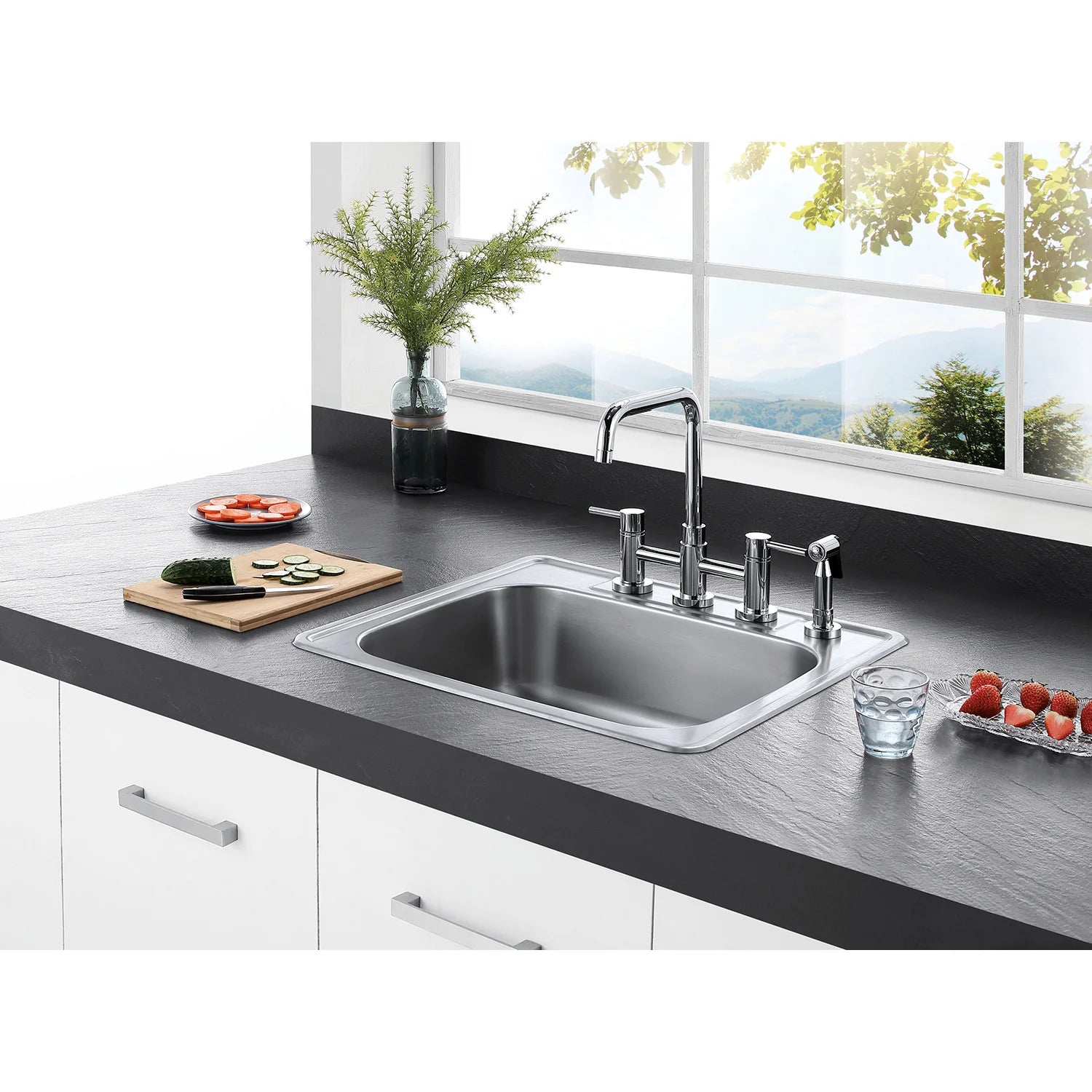 Polished chrome bridge kitchen faucet with side sprayer on stainless double sink