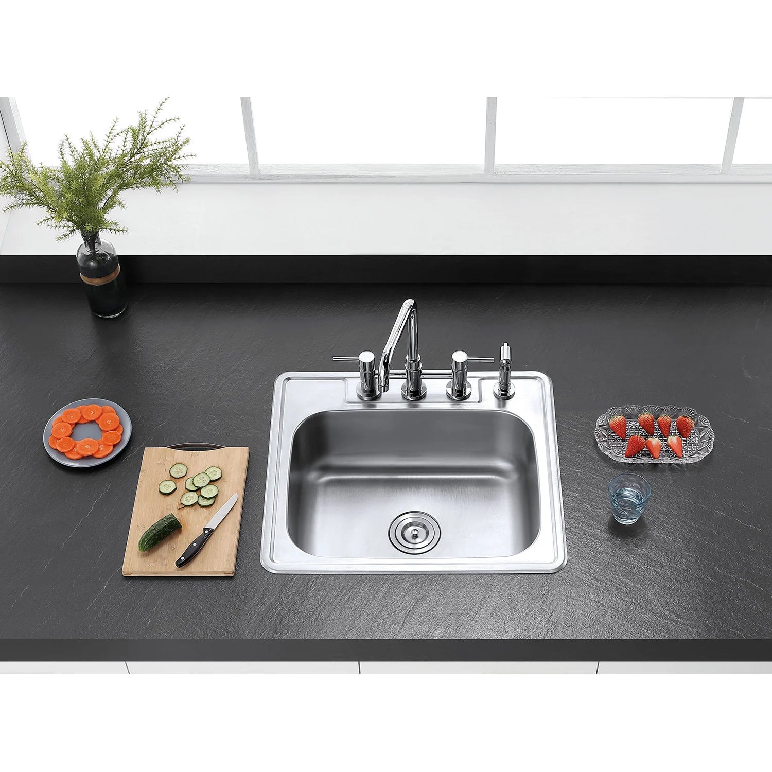Polished chrome bridge kitchen faucet with side sprayer above stainless kitchen sink