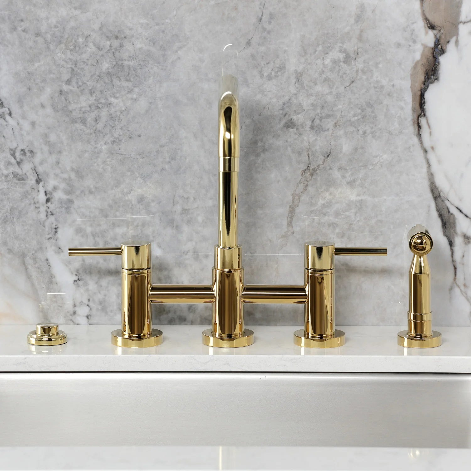 Polished brass bridge kitchen faucet with tall gooseneck and side sprayer controls